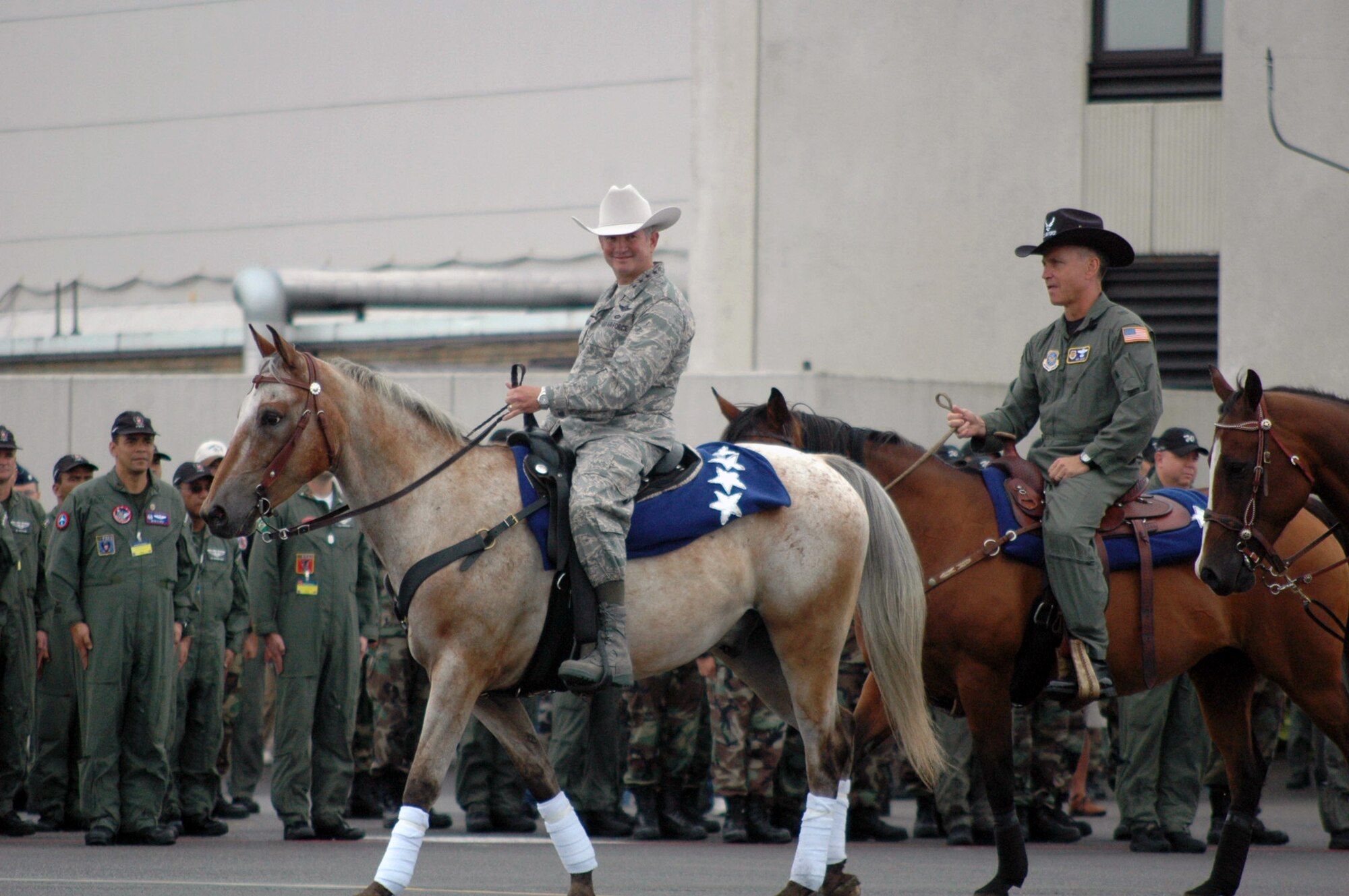 Air Mobility Command Commander, Gen. Duncan McNabb, and Air Mobility Rodeo 2007 Commander, Brig. Gen. Kip Self, ride on horses during their entrance for the opening ceremony for Rodeo July 22, at McChord Air Force Base, Wash. U.S. and international teams were formed up for the event.  Rodeo, sponsored by Air Mobility Command, is a readiness for U.S. and international mobility air forces.  Besides numerous international teams and observers, there are also teams from across the Air Force, Air Force Reserve, Air National Guard, and the U.S. Marine Corps. (U.S. Air Force Photo/Tech. Sgt. Scott T. Sturkol)