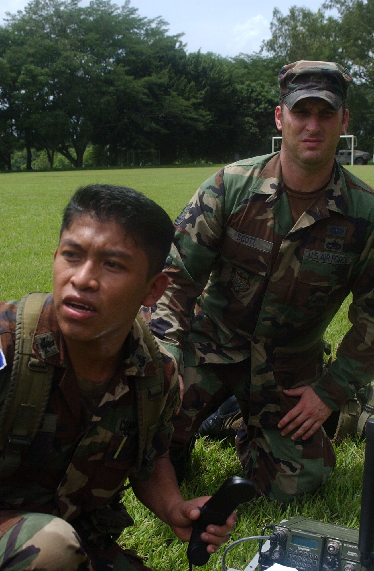 Tech Sgt. Jeffery Scott looks on an El Salvadorian soldier awaits coordinates so he can call in a simulated helicopter, to medivac wounded soldiers from the battle field. During the week-long military-to-military training Sergeant Scott instructed soldiers on the use of communications equipment to prepare them for their upcoming deployment to support Operation Iraqi Freedom. Air Force photo by Senior Airman Shaun Emery.                                                              