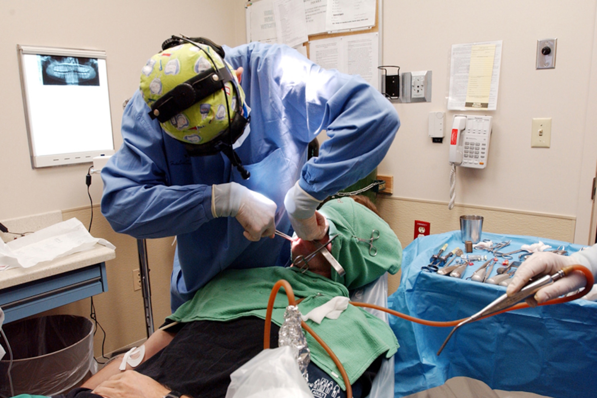 A surgeon from the 1st Special Operations Dental Squadron performs oral surgery on an Airman. The dental clinic will perform more than 6,000 procedures this year. Photo by Staff Sergeant Mareshah Haynes.