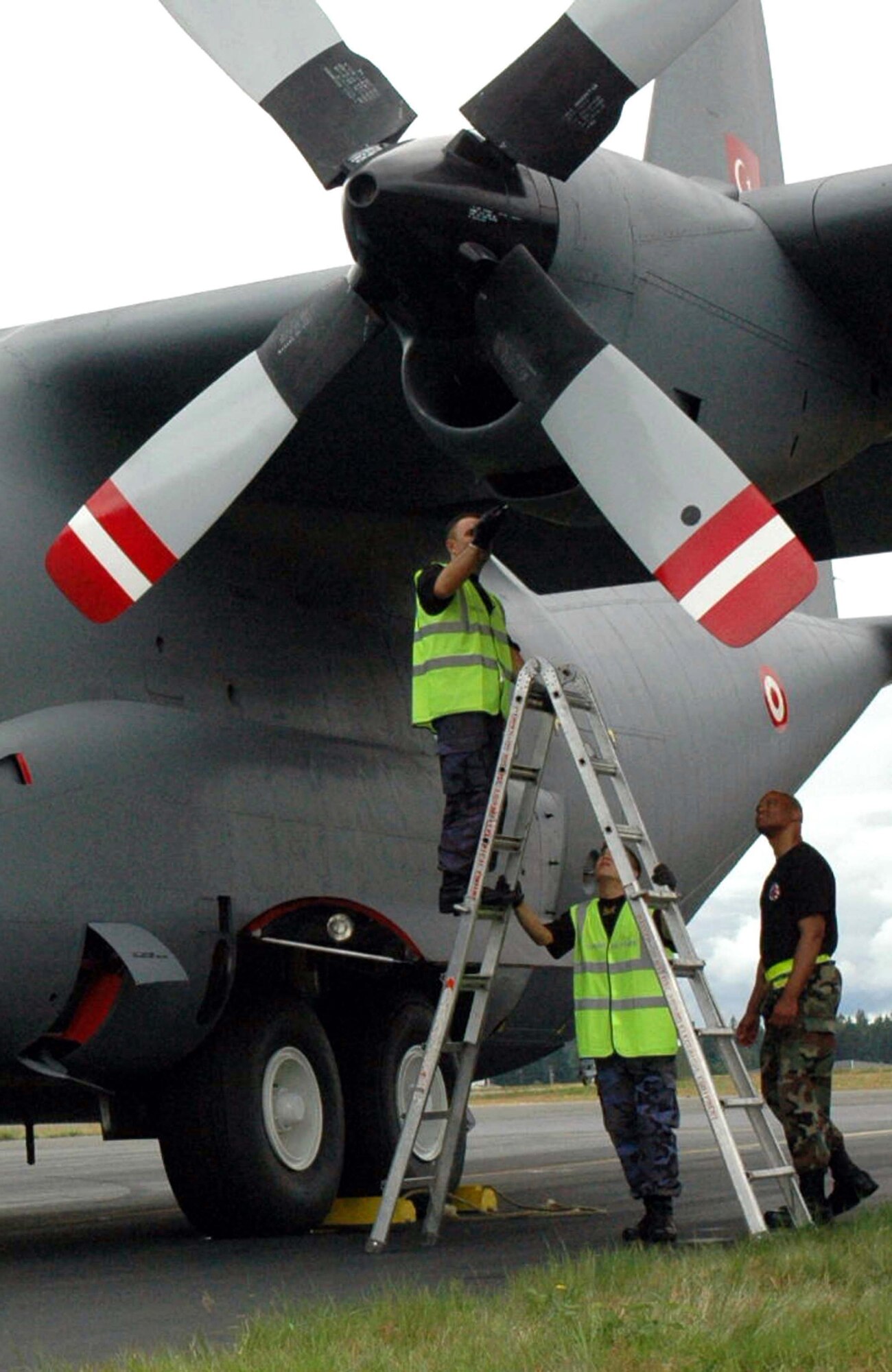 Tech. Sgt. Trey Woodward, 446th Aircraft Maintenance Squadron, performs one final check of Turkey's C-130E before its first flight at the Air Mobility Command Rodeo 2007. Sergeant Woodward worked side by side with Turkish maintainers to perform emergency maintenance on their airplane, enabling the team to fly in the competition. (U.S. Air Force Photo/Staff Sgt. Nick Przybyciel)