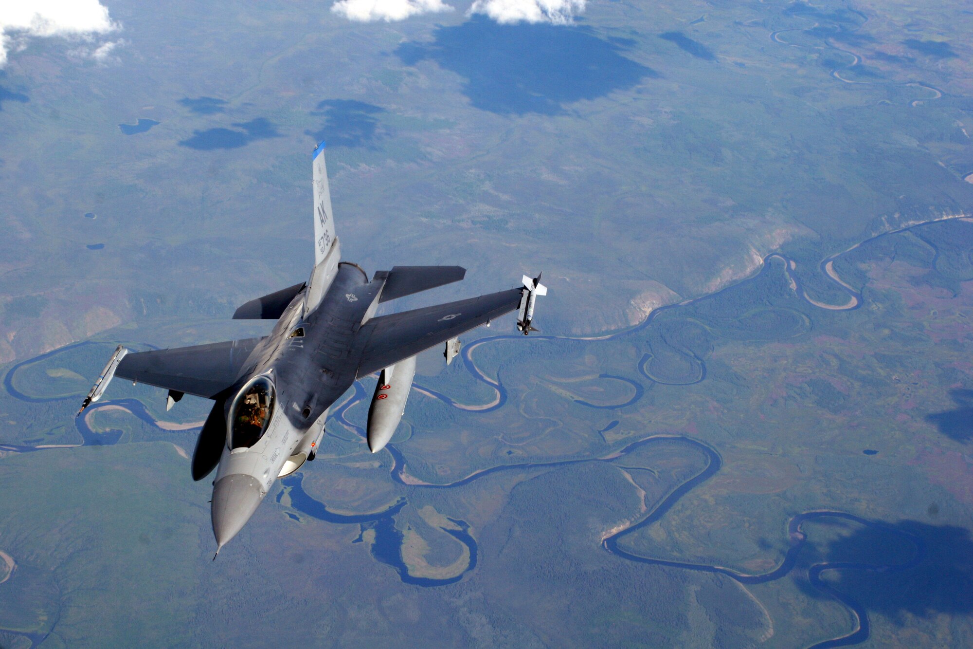 EIELSON AIR FORCE BASE, Alaska -- An F-16 from the 18th Fighter Squadron here flies away after refueling from a KC-135 Stratotanker during Red Flag Alaska July 20, 2007. More than 80 aircraft and 1500 servicemembers from 6 different countries are flying together over the Last Frontier July 12-27 to sharpen their combat skill in simulated combat sorties.  (U.S. Air Force photo by Capt. Tana R.H. Stevenson)