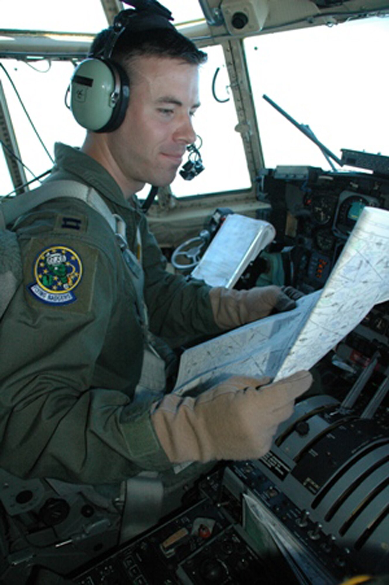 Capt. Grady Dieckert checks his charts during an aeromedical training mission July 19 that originated at Pope Air Force Base, N.C.  The mission provided the opportunity for the Reserve flying unit there to train with one of the active duty aeromedical evacuation units there.  Captain Dieckert is a pilot with the Air Force Reserve Command's 440th Airlift Wing.  The flight was one of the first operational missions for the 440th AW from its new location at Pope AFB.  The Reserve unit moved to North Carolina from Wisconsin in June. (U.S. Air Force photo/Maj. Ann Knabe)