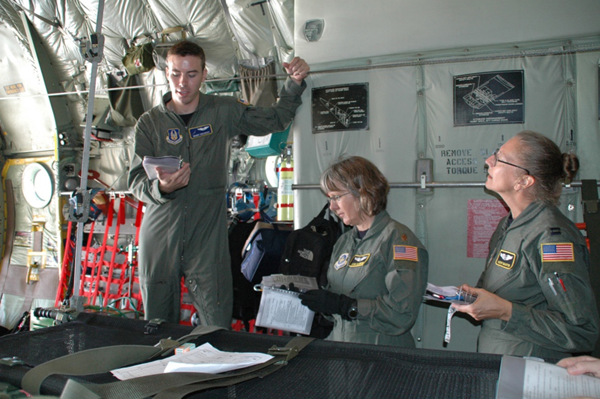 Capt. Grady Dieckert briefs Maj. Joni Clemens and Capt. Kathy Martin prior to flying an aeromedical training mission on July 19 from Pope Air Force Base, N.C. Major Clemens, with the 43rd Aeromedical Evacuation Squadron at Pope AFB, served as the medical crew director.  Captain Martin is the 43rd AES element chief for aircrew training. Captain Dieckert is a pilot with the Air Force Reserve Command's 440th Airlift Wing.  The flight was one of the first operational missions for the 440th AW from its new location at Pope AFB.  The Reserve unit moved to North Carolina from Wisconsin in June. (U.S. Air Force photo/Maj. Ann Knabe) 