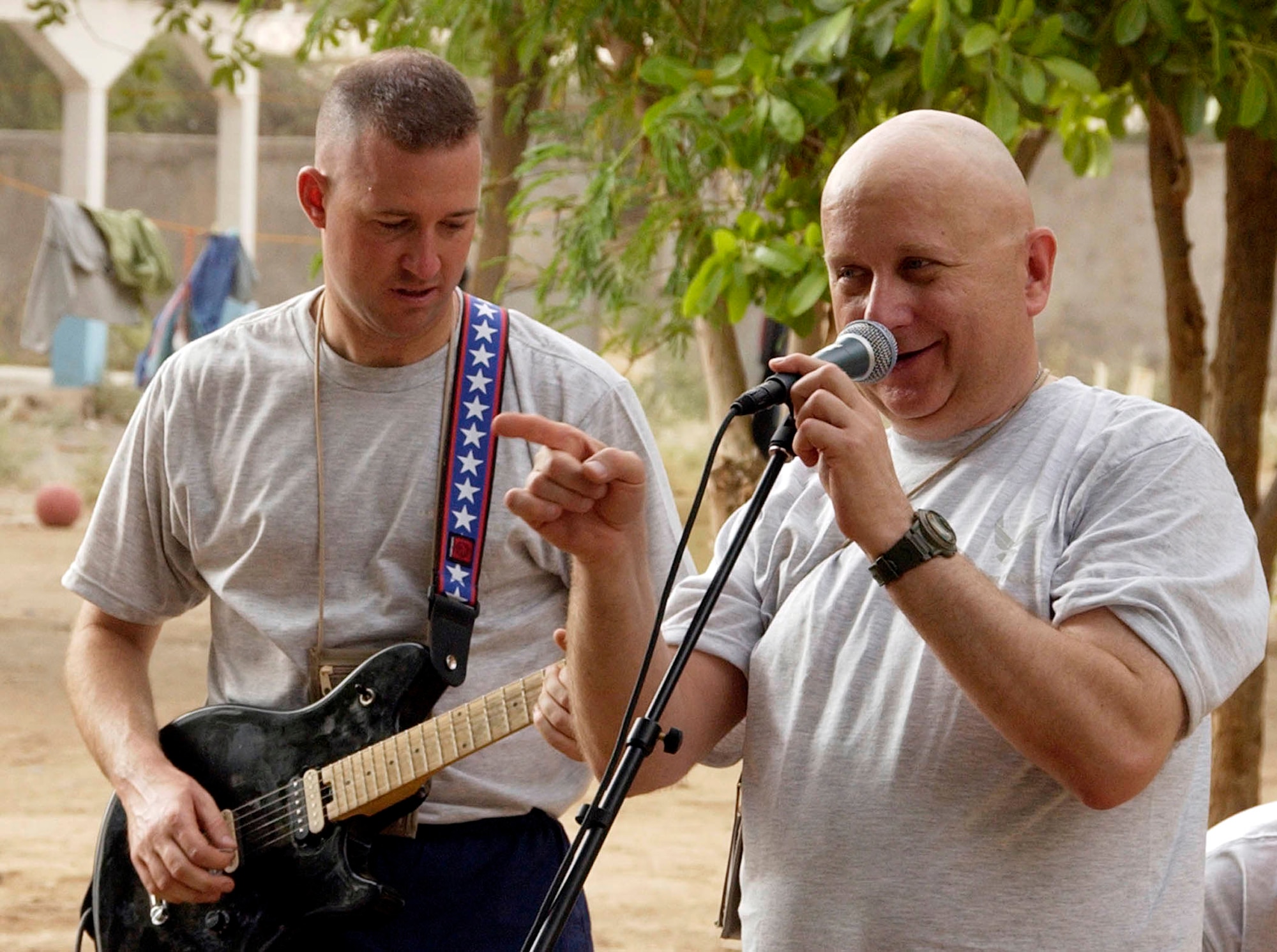Master Sgt. James Filipek sings "Born to be Wild" at an orphanage in Djibouti as Staff Sgt. Scott Filipek backs him on the guitar.  The Filipeks with other members of the Illinois Air National Guard's Band of the Midwest deployed to Southwest Asia for 30 days and toured as the Central Air Forces band "Thunder Roll."  (U.S. Air Force photo/Staff Sgt. Samuel King Jr.)                              