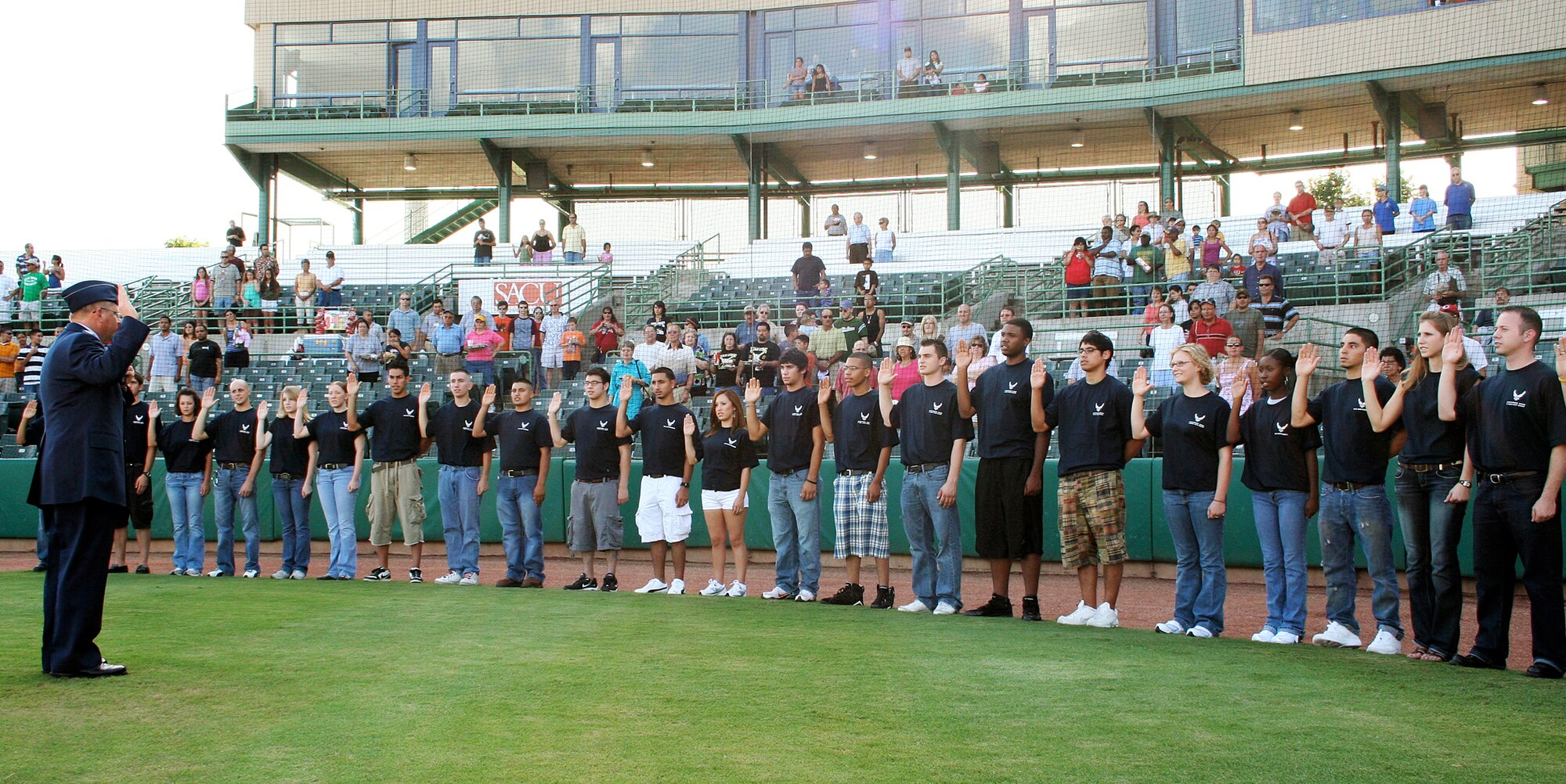 Thirty one young men and woman in the Delayed Enlistment Program took the oath of enlistment into the Air Force, July 22 at Wolff Municipal Stadium in San Antonio.  The DEP swear-in kicked-off military appreciation night at the San Antonio Missions baseball game against the Frisco Roughriders. Colonel Daniel Woolever, 369th Recruiting Group commander, administered the oath.  (Air Force photo/Senior Master Sgt. Louis Despres)