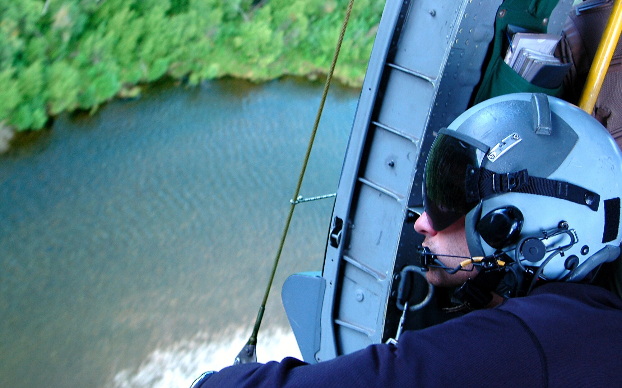 A pararescueman keeps watch out the side door of an HH-60 Pave Hawk helicopter en route to a combat search and rescue training scenario at Red Flag-Alaska 07-3, a multinational air combat training exercise held at the Pacific Alaska Range Complex.  The Pave Hawk and crew are with the 210th Rescue Squadron from Kulis Air National Guard Base, Alaska. (U.S. Air Force photo/Staff Sgt. Shawn J. Jones) 