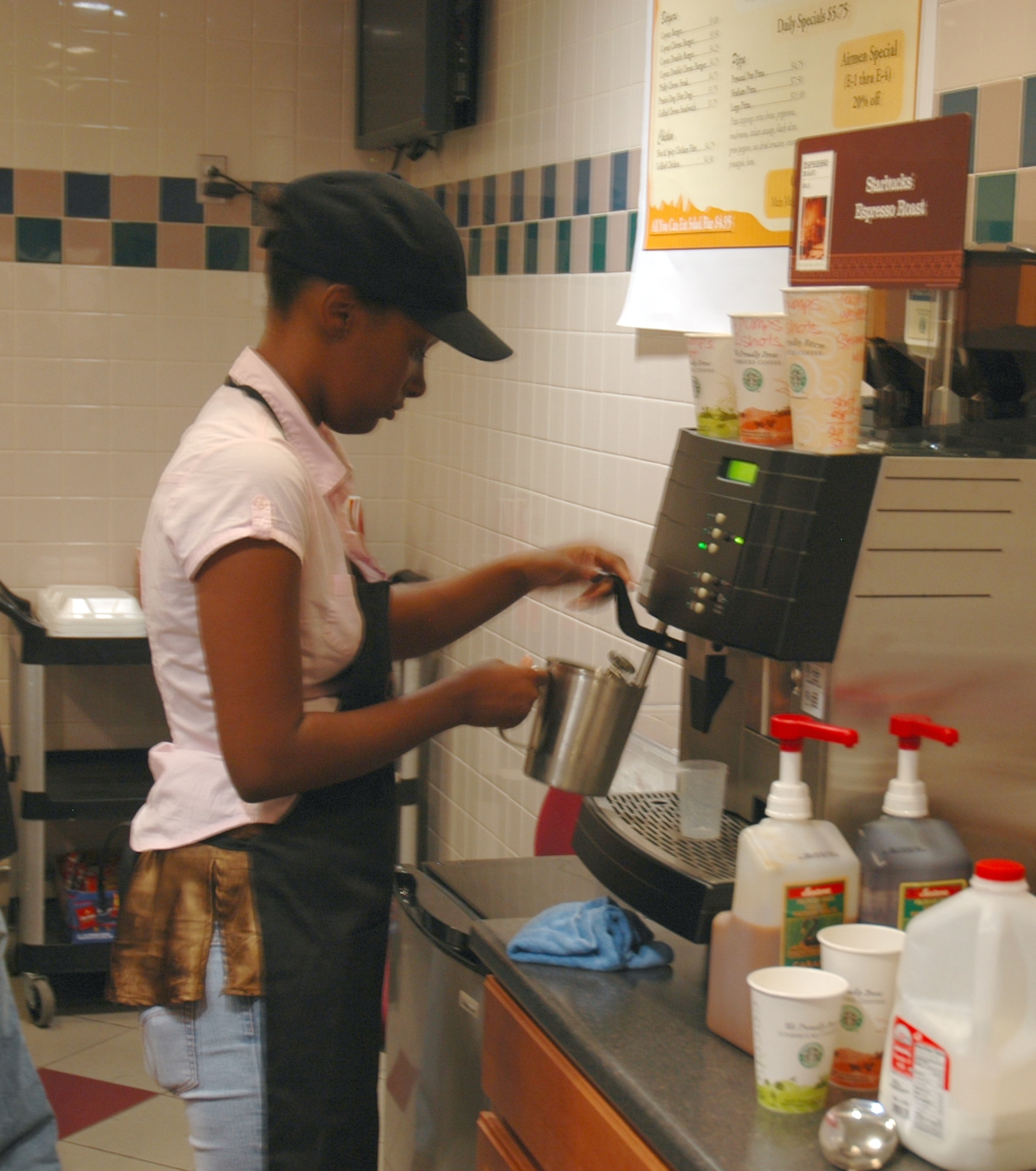 BUCKLEY AIR FORCE BASE, Colo. -- Ms. Ashleah Kenoly prepares a mocha this morning during Starbucks' grand opening at Newtch's Den. Starbucks opens daily at 5 a.m. (U.S. Air Force photo by Staff Sgt. Sanjay Allen)
