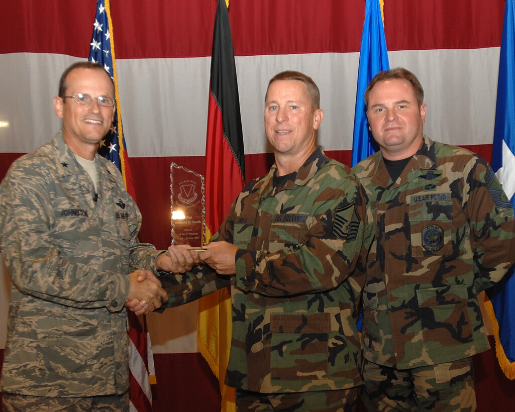 Brig. Gen. Rich Johnston, 86th Airlift Wing commander, and Chief Master Sgt. Tom Baker, acting 86th AW command chief, presents the outstanding Senior Non-Commissioned Officer of the Quarter Award to Master Sgt. Richard E. Smith July 20, 2007, at the  86th AW Commander call.


