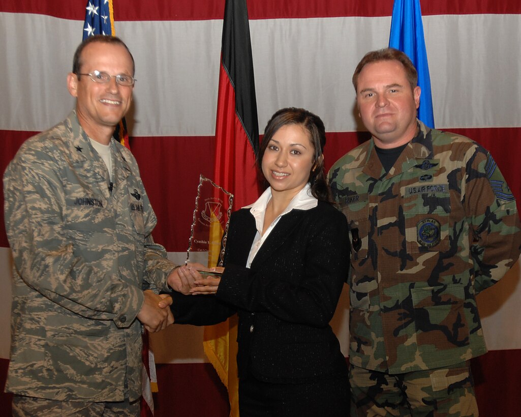Brig. Gen. Rich Johnston, 86th Airlift Wing commander, and Chief Master Sgt. Tom Baker, acting 86th AW command chief, presents the outstanding Civilian of the Quarter Category I Award to Mrs. Cynthia Y. Floyd July 20, 2007, at the  86th AW Commander call