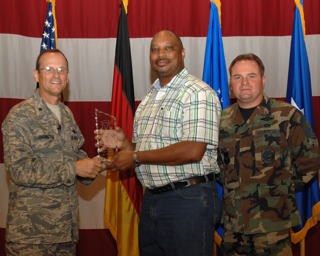 Brig. Gen. Rich Johnston, 86th Airlift Wing commander, and Chief Master Sgt. Tom Baker, acting 86th AW command chief, presents the outstanding Civilian of the Quarter Category II Award to Mr. Roger G. Barnett July 20, 2007, at the  86th AW Commander call.

