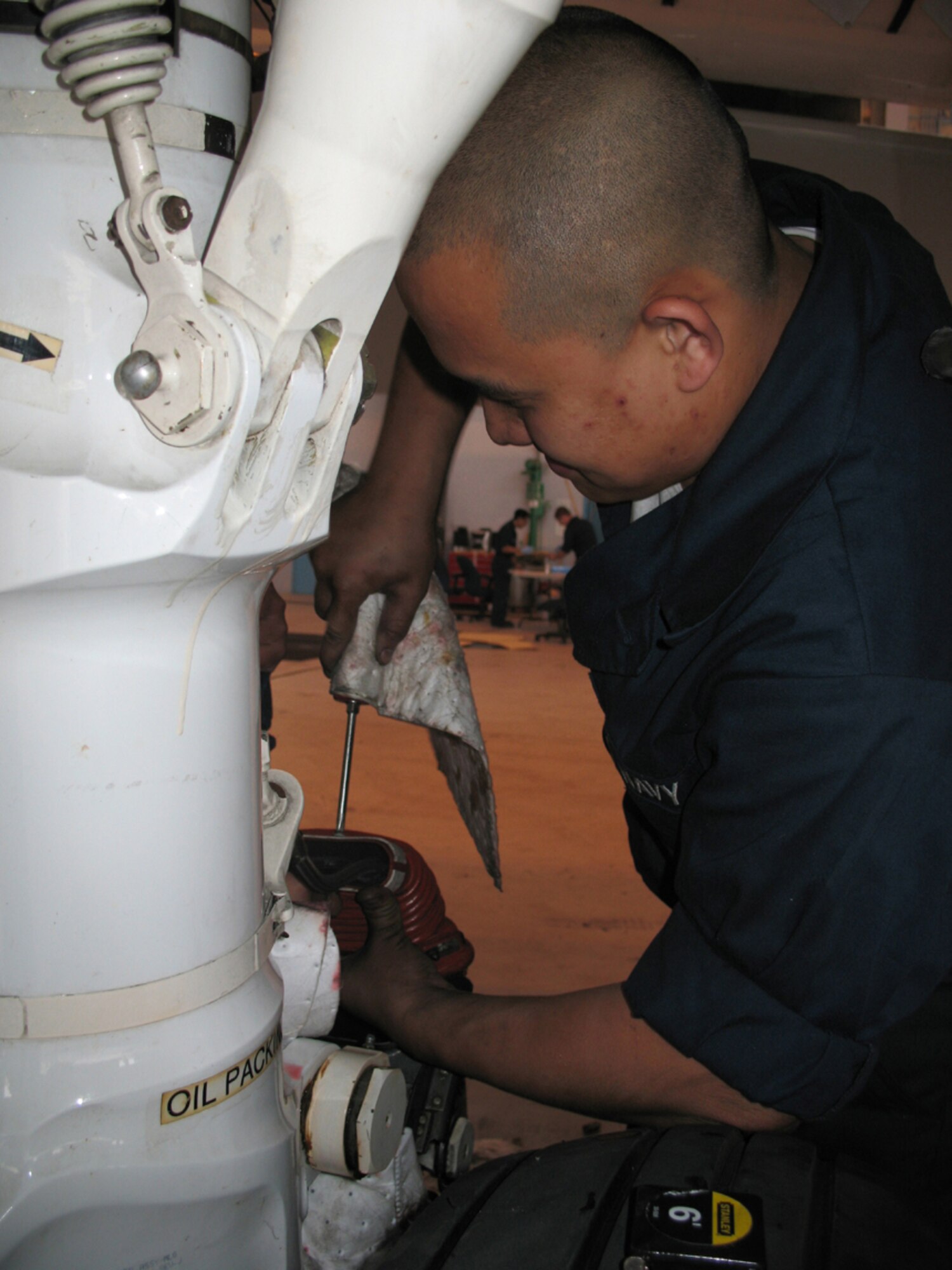 MISAWA AIR BASE, Japan -- A maintainer works on a part of the P-3 Orion aircraft here.  The men and women who are part of the P-3 squadron work at a facility that is able to do specialized work, the only facility in the Pacific Theater equipped to do so.  (Photo by Senior Airman Sasha A. Navarro-Schmidt)