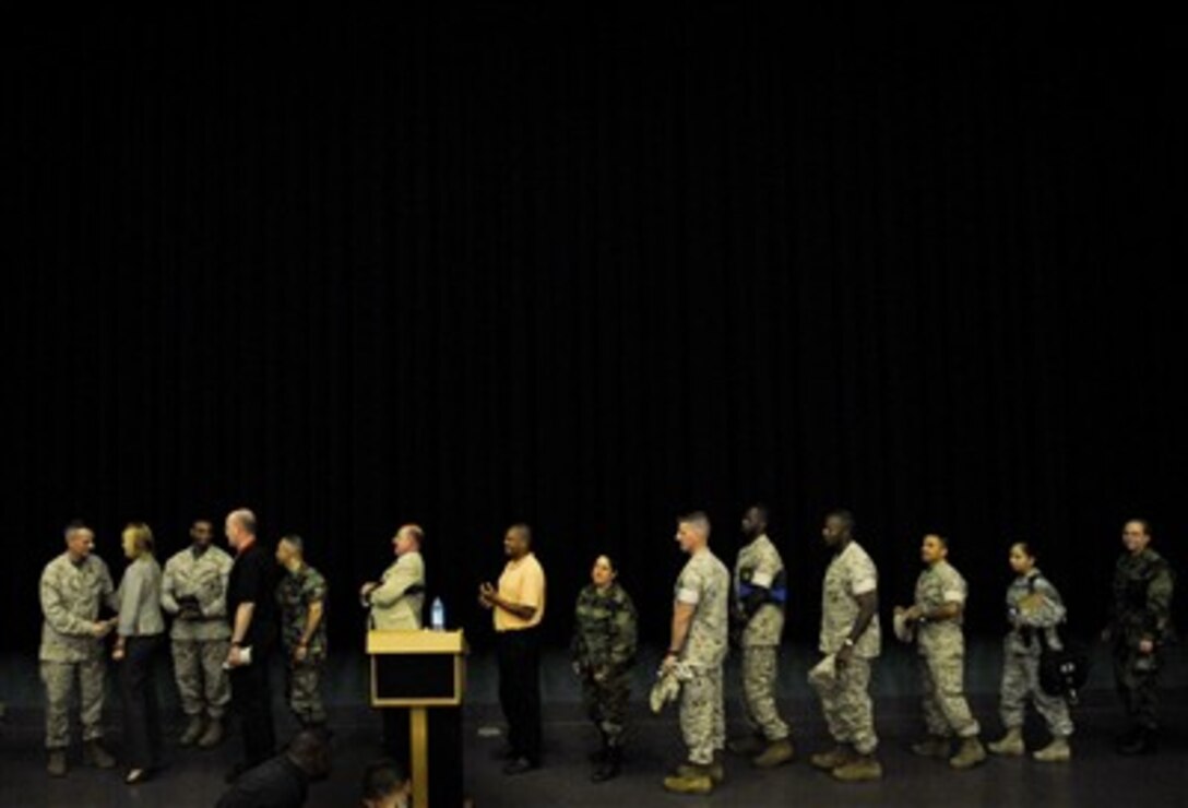 Chairman of the Joint Chiefs of Staff Gen. Peter Pace (left), U.S. Marine Corps, personally thanks approximately 500 of the U.S. European Command staff after a town hall meeting in Stuttgart, Germany, on July 20, 2007.  Pace is in Germany to visit recovering soldiers at Landstuhl Regional Medical Center and meet troops stationed in Germany.  