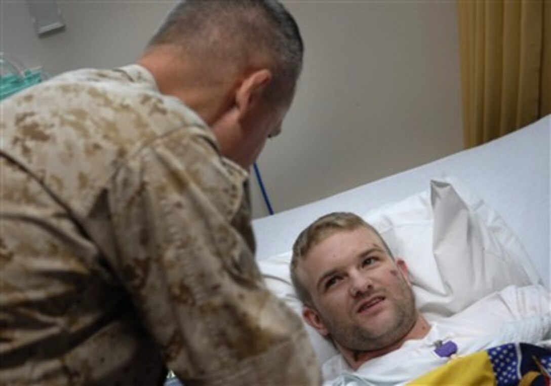 Army Spc. Cocin Laird Pearcy (right) talks with Chairman of the Joint Chiefs of Staff Gen. Peter Pace, U.S. Marine Corps, after Pace presented the Purple Heart medal to Pearcy at Landstuhl Regional Medical Center, Germany, on July 21, 2007.  Pace is in Germany to visit recovering soldiers at Landsthul Regional Medical Center and meet troops stationed in Germany.  Landstuhl is the largest American hospital outside the United States.  
