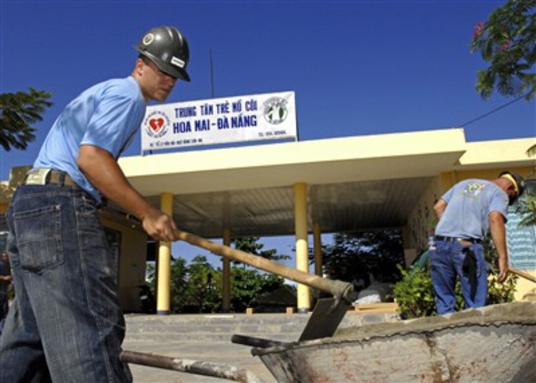 U.S. Navy Seabee Petty Officer 3rd Class Brian Laferriere mixes cement for a playground at Hoi Mai Orphanage in Da Nang City, Vietnam, on July 20, 2007.  Seabees with Naval Mobile Construction Battalion 7 and Amphibious Construction Battalion 1 are deployed in support of Pacific Partnership, a humanitarian assistance mission in Southeast Asia and Oceania that includes specialized medical care and various construction and engineering projects.  
