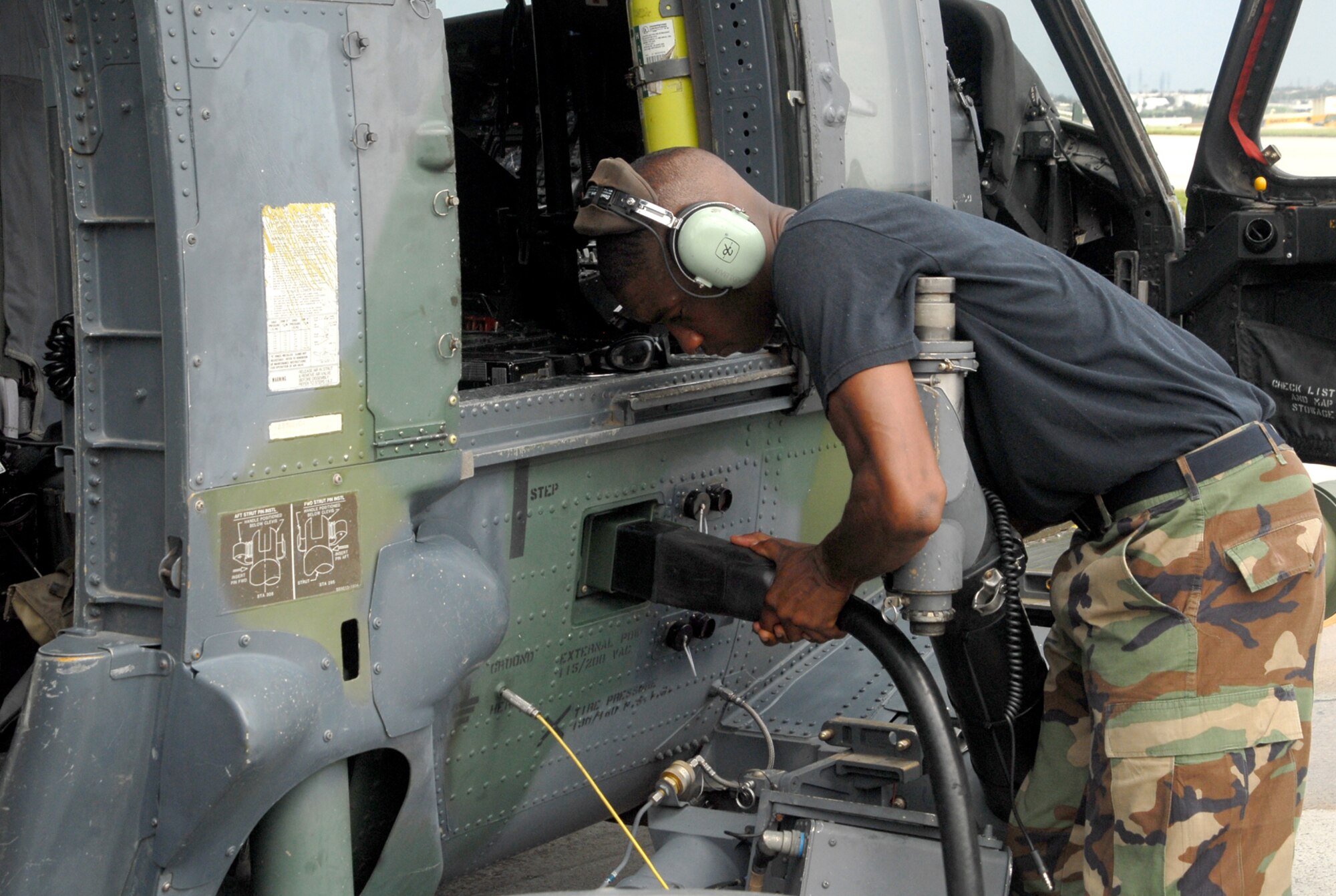 Staff Sgt. Birdeal Ferguson, a crew chief with the 718th Aircraft Maintenance Squadron, Kadena Air Base, Japan, uses a generator to power up an HH-60 Pave Hawk helicopter at Kadena July 23.  The 33rd Rescue Squadron conducted training this week in preparation for its upcoming deployment to Kandahar, Afghanistan, to conduct combat search and rescue and medical rescue missions in support of Operation Enduring Freedom. The squadron is heading back to Afghanistan after returning from a four-month deployment to Kandahar in May. (U.S. Air Force Photo/Staff Sgt. Joshua J. Garcia)