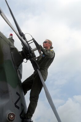 Staff Sgt. Elizabeth Philpott, flight engineer for the 33rd Rescue Squadron at Kadena Air Base, Japan, checks the rear rotor of an HH-60 Pave Hawk helicopter during a pre-flight inspection during a training exercise at Kadena July 23. The squadron conducted training this week in preparation for an upcoming deployment Kandahar, Afghanistan, to conduct combat search and rescue and medical rescue missions in support of Operation Enduring Freedom. The squadron is heading back to Afghanistan after returning from a four-month deployment to Kandahar in May. (U.S. Air Force Photo/Staff Sgt. Joshua J. Garcia)