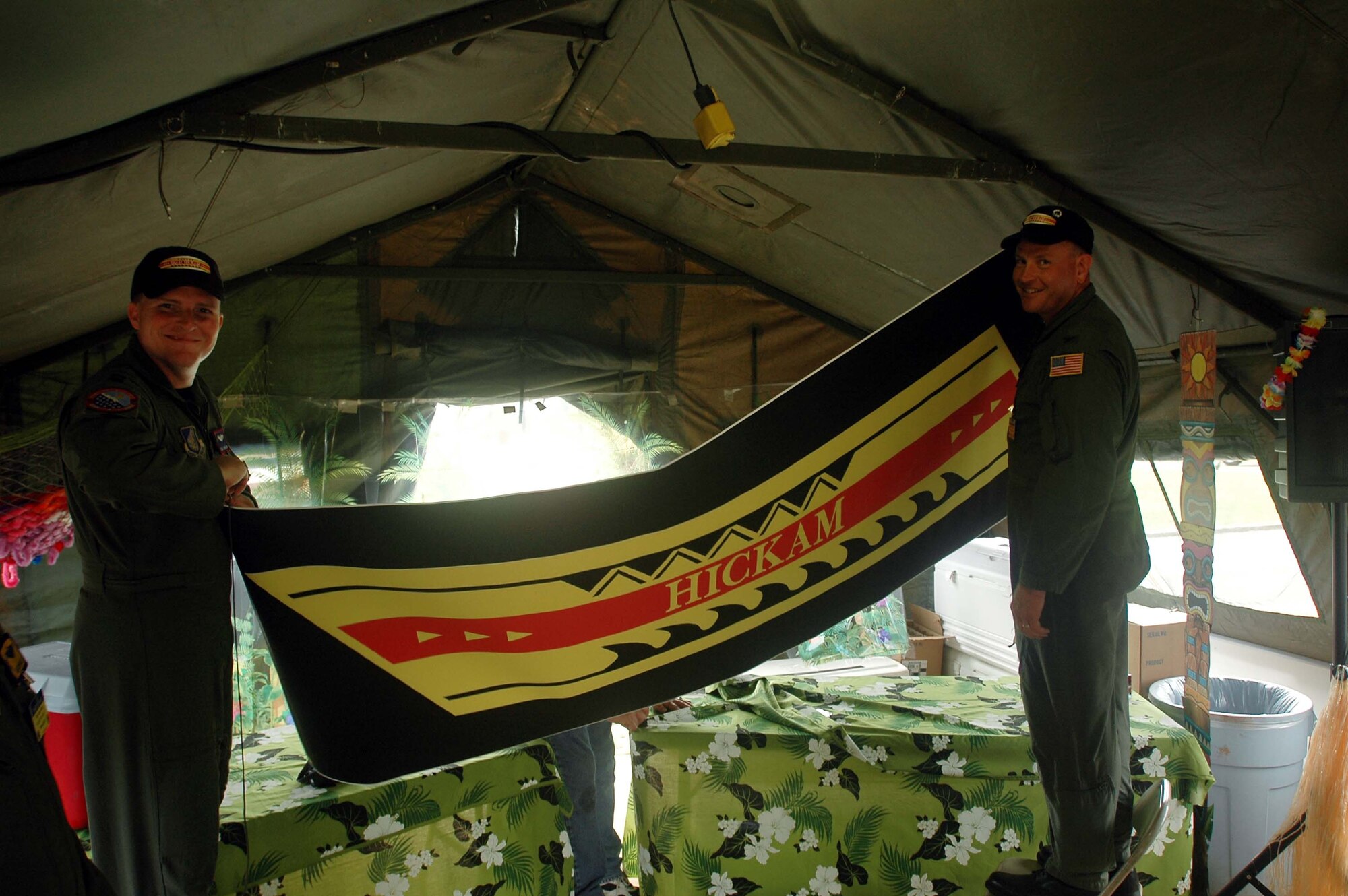 Col. Andy Hockman, 15th Operations Group commander, and Capt. Todd Strickland, competing pilot, put the finishing touches on Hickam's hospitality tent at the Ranier Ranch.   This compound is home to the international hospitality tents where teams can mingle at end of the long competition days. 
