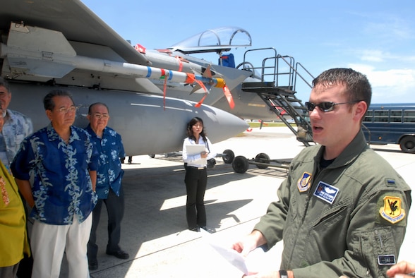 First Lt. Alan Schulenberg, an F-15C pilot with the 44th Fighter Squadron at Kadena Air Base, Japan, explains the functions of an F-15 fighter jet to Okinawa business leaders during a community relations tour at Kadena July 16. This tour was part of the base’s co-commanders program in which senior leaders on Kadena are paired with local community leaders.  The program objective is to foster close relationships between the base and local communities, while promoting a better understanding of Kadena’s mission.  Kadena’s leaders also gain insight into Okinawa public perspectives regarding U.S. and Air Force forces on Okinawa.  (U.S. Air Force/Senior Airman Darnell T. Cannady)