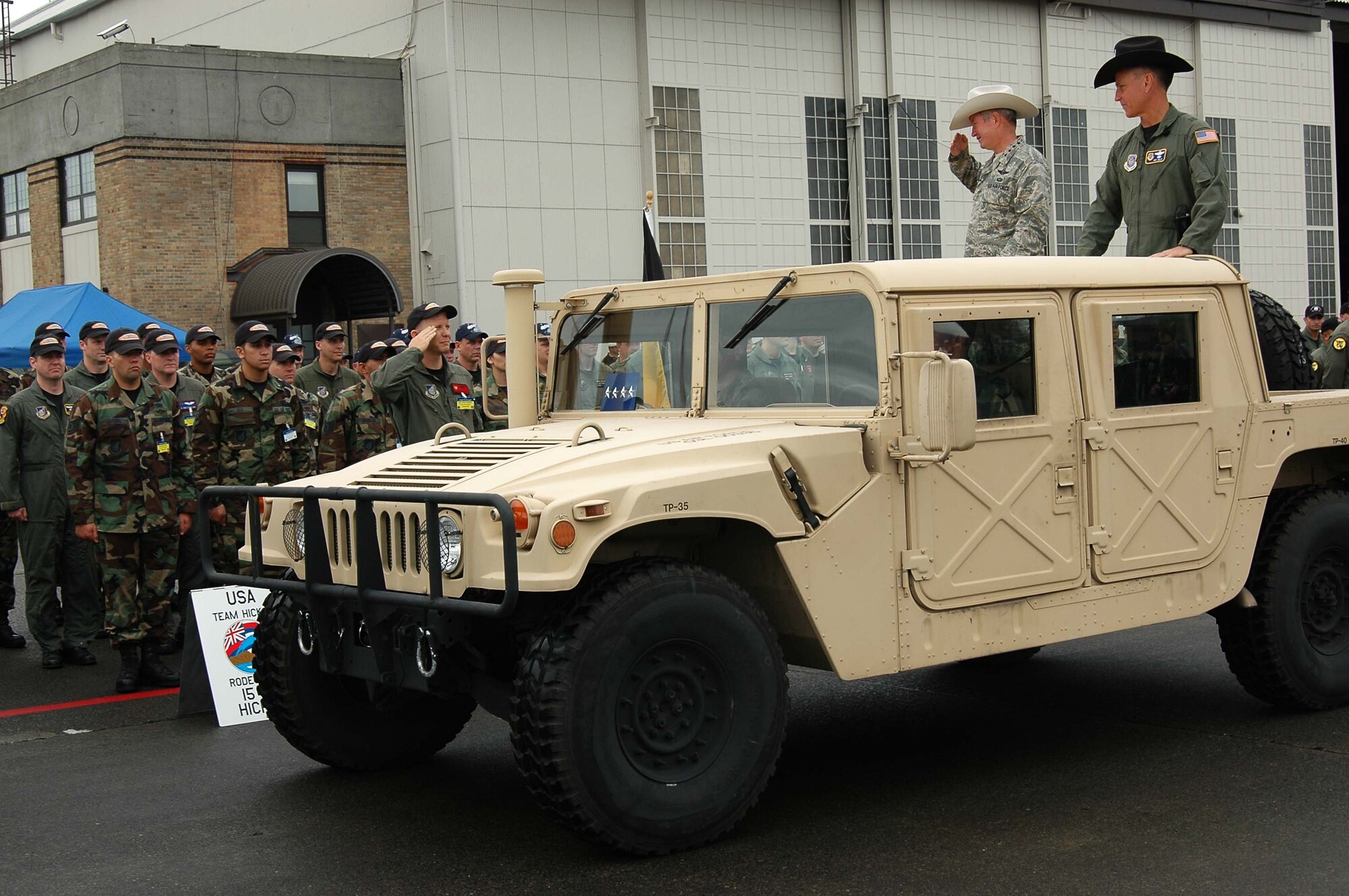 Maj. Landon Henderson, Team Hickam Rodeo commander, salutes Gen. Duncan J. McNabb, commander of Air Mobility Command, as the general makes his way around to each of the competing teams at the opening ceremony of Rodeo 2007 Sunday morning.  Less than 24 hours before, Team Hickam kicked off the event with their precision landing on McChord's runway.
