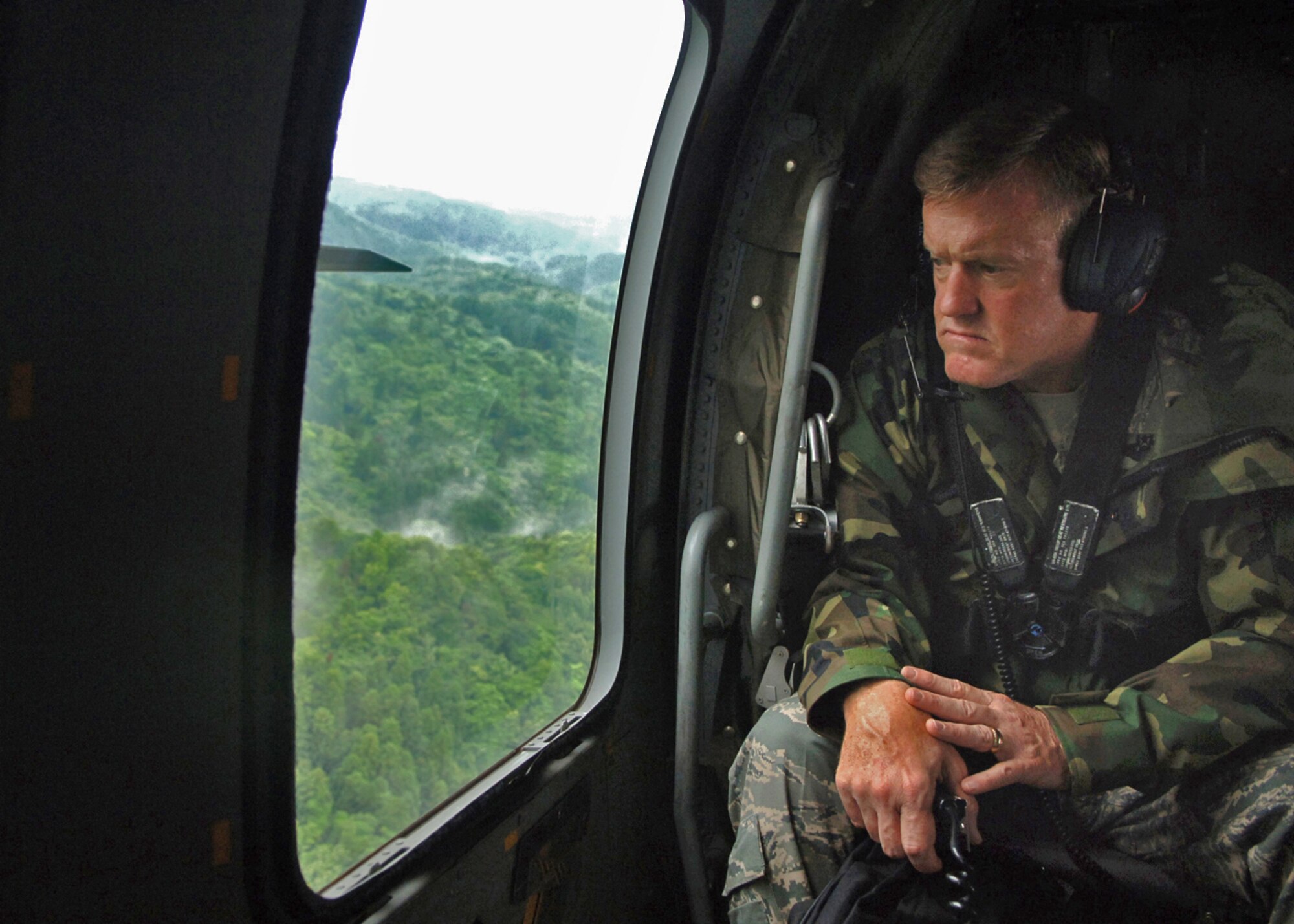 Lt. Gen Bruce Wright U.S. Forces Japan commander, looks out from an Japan Self Defense Force HH-60 Blackhawk on to damage caused by the July 16 earthquake . The 6.5 magnitude earthquake struck areas in the Niigata Prefecture on the northwest side of Japan. 
(U.S. Air Force photo by Senior Airman Veronica Pierce)