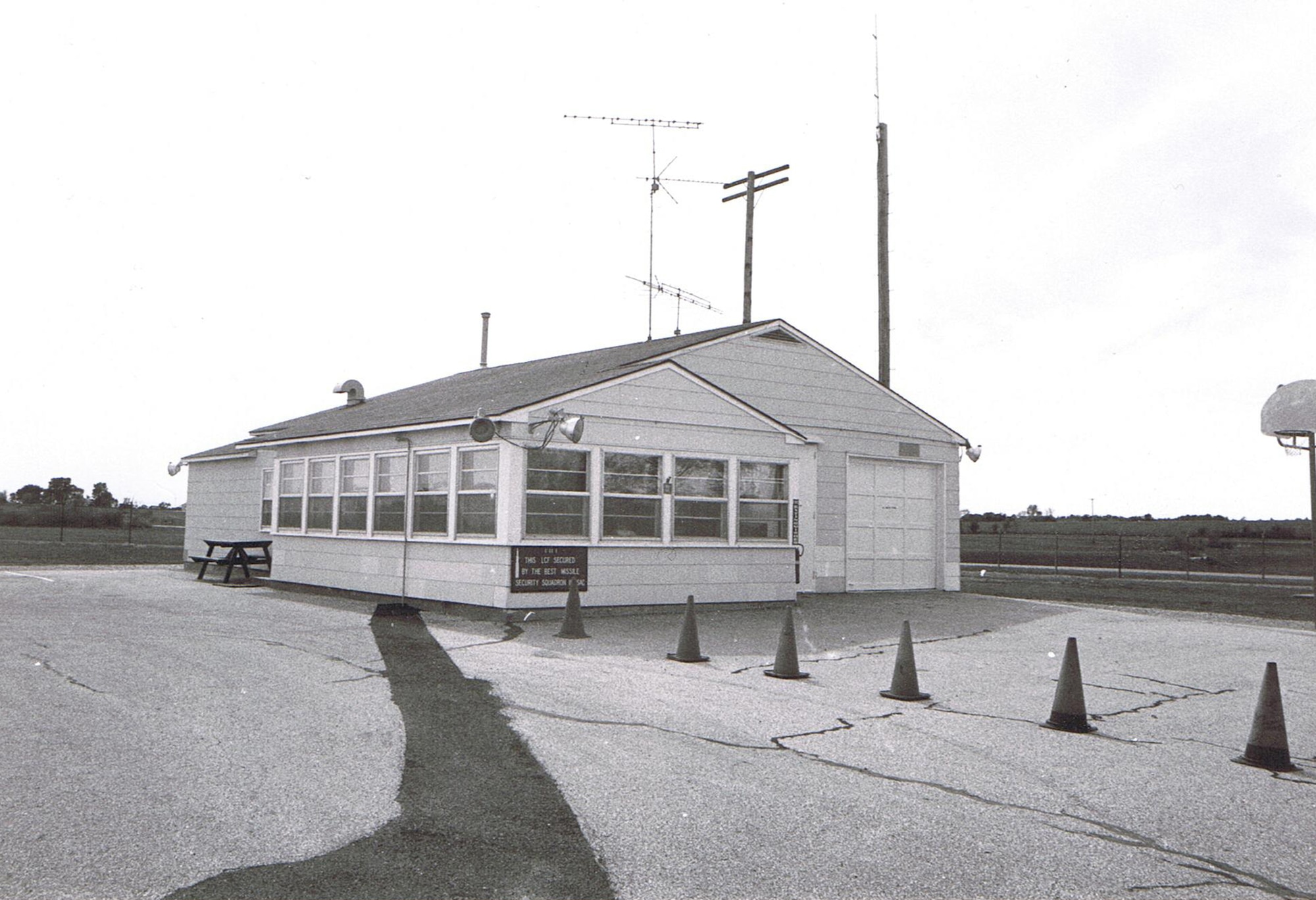 WHITEMAN AIR FORCE BASE, Mo. -- An example of a Minuteman II launch control facility. Launch control facility sites like this one were designed to function even after the initial exchanges of a nuclear war. Self-contained, the underground portion housed batteries, a power generator, telephone switches for the underground cable system, and air regeneration equipment. Redundancies in the system meant that even a damaged LCF would likely have the minimal capability to perform its mission. The facility was manned by 10 people. Two individuals were the crews downstairs. The remaining eight included the facility manager who was usually the ranking enlisted person on site. The next ranking individual was the flight security controller who insured the security of the site and acted as a liaison with the crews downstairs. (U.S. Air Force photo)
