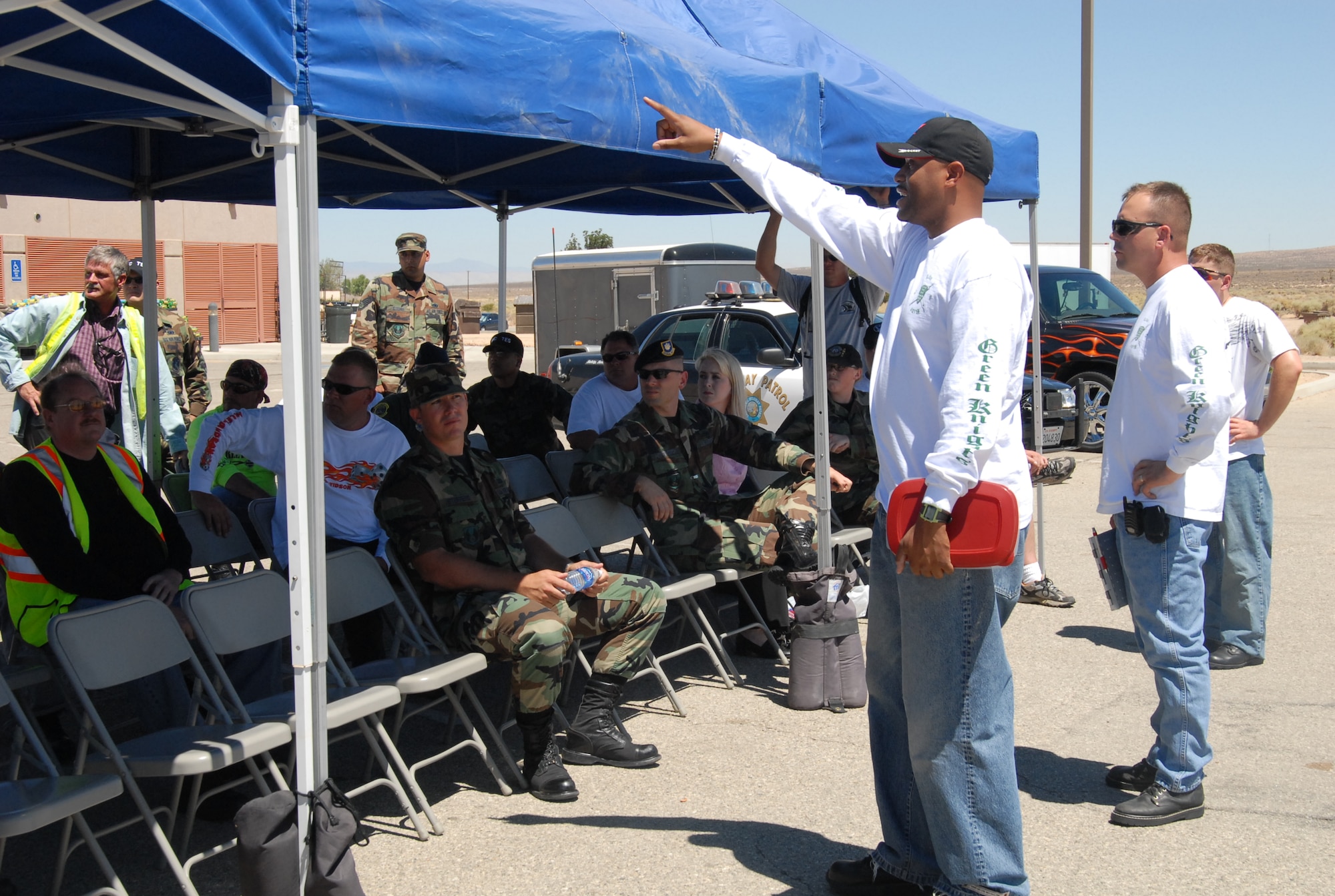 Tech. Sgts. Ross Seaborn (center) and Jon Camplin (right), from the Muroc Green Knights motorcycle club, answer questions from attendees during a motorcycle safety day event at the Base Exchange parking lot July 18. The event provided base motorcycle riders a proficiency course to hone their riding skills, briefings on regulations and safety equipment and a chance to talk to motorcycle officers from the California Highway Patrol. (Photo by Tech. Sgt. Jay Fury)