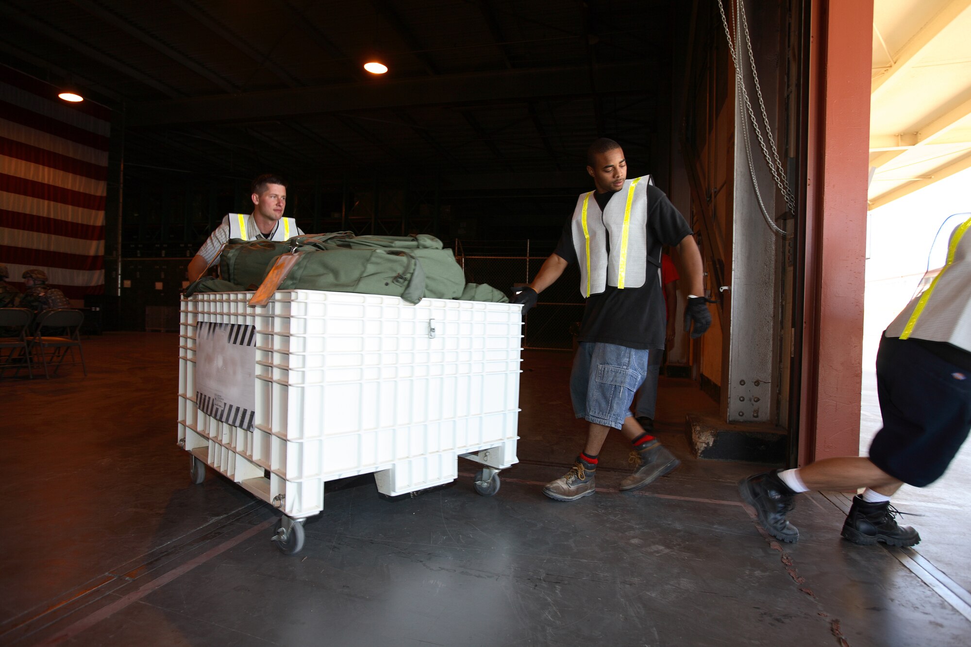Deployment Operations Division personnel transport cargo during the Phase I exercise July 19. They handle various items used for deployments such as mobility bags, insect repellant, weapons and individual body armor. (Photo by Jet Fabara)