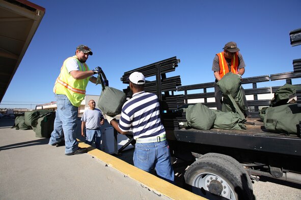 Deployment Operations Division personnel transfer duffel bags during the Phase I exercise July 19. The main goal of the division is to support both 95th Air Base Wing and 412th Test Wing personnel who may be tasked for a deployment in support of the Global War on Terror. (Photo by Jet Fabara)