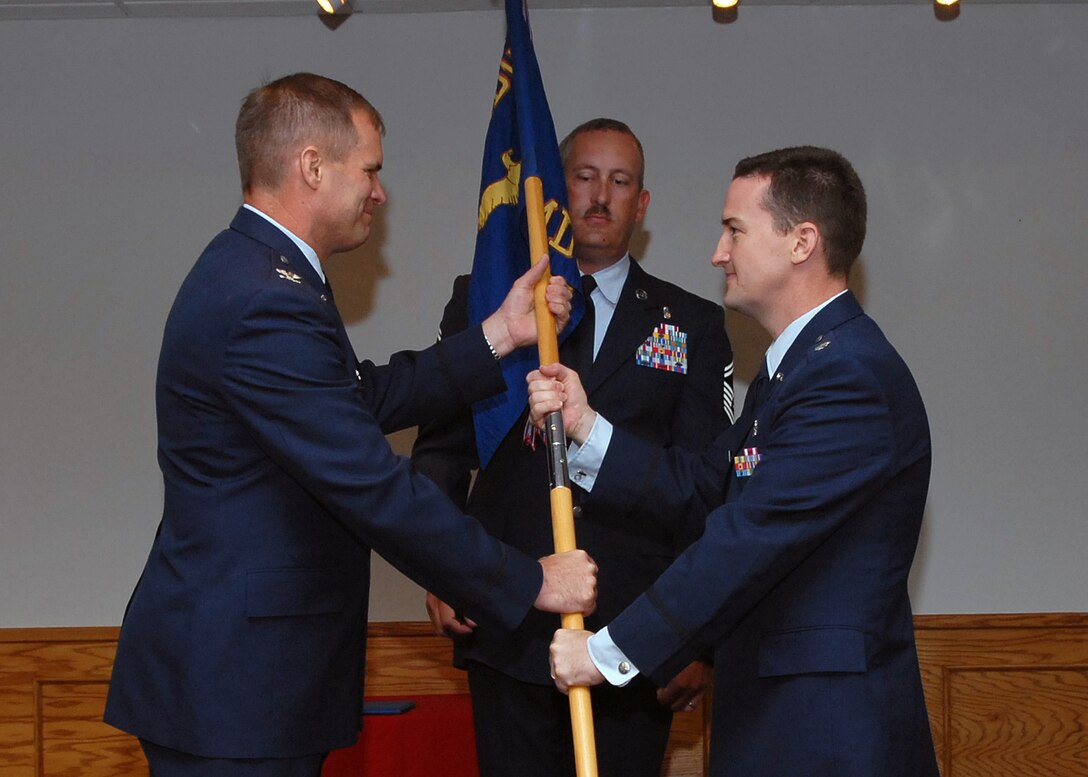 Col. James King, 82nd Medical Group commander, hands the guidon to incoming 82nd Medical Operations Squadron commander Lt. Col. Bret Burton at the 82nd MDOS change of command ceremony July 20 at the Sheppard Club. (U.S. Air Force photo/Mike Litteken)