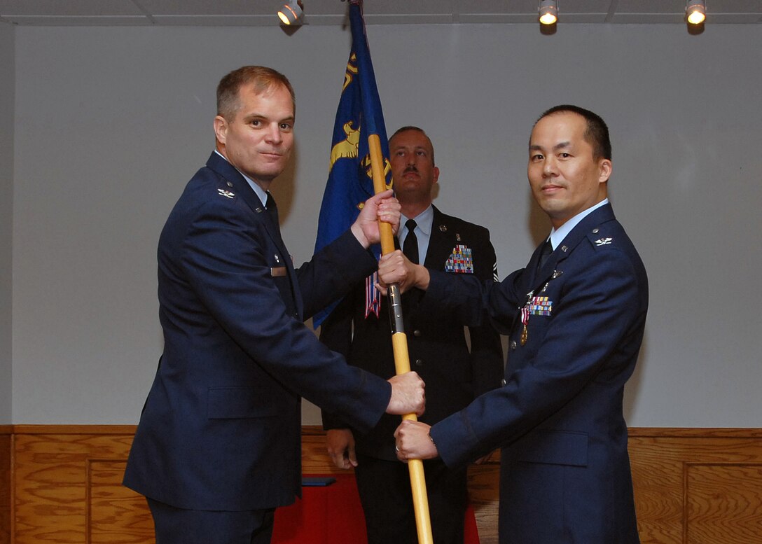 Col. James King, 82nd Medical Group commander, accepts the guidon from outgoing 82nd Medical Operations Squadron commander Col. John Chu at the 82nd MDOS change of command ceremony July 20 at the Sheppard Club. (U.S. Air Force photo/Mike Litteken)