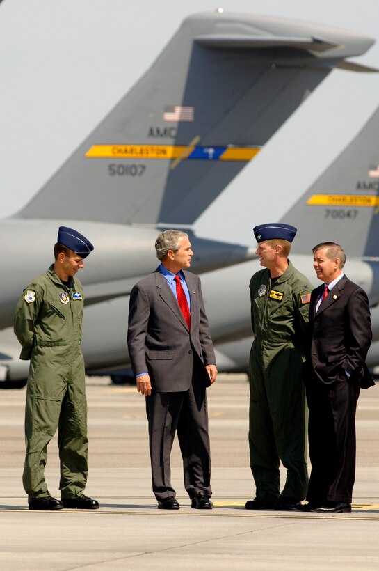 Col. Mark Brauknight, 315th Airlift Wing acting commander, President George Bush, Col. John "Red" Millander, 437th Airlift Wing commander and Sen. Lindsey Graham tour the Charleston Air Force Base flightline today. President Bush visited Charleston AFB, took a tour of a static C-17, ate lunch with Airmen from the base and talked about the Global War on Terrorism. (U.S. Air Force Photo/Airman 1st Class Nicholas Pilch)

