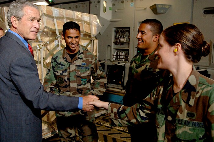 President George Bush shakes hands with Senior Airman Shannon Jones, 437th Aerial Port Squadron cargo processor, in a Charleston C-17 Globemaster III on the Charleston Air Force Base flightline today. President Bush visited Charleston AFB, took a tour of a static C-17, ate lunch with Airmen from the base and talked about the Global War on Terrorism. (U.S. Air Force Photo/Airman 1st Class Nicholas Pilch)