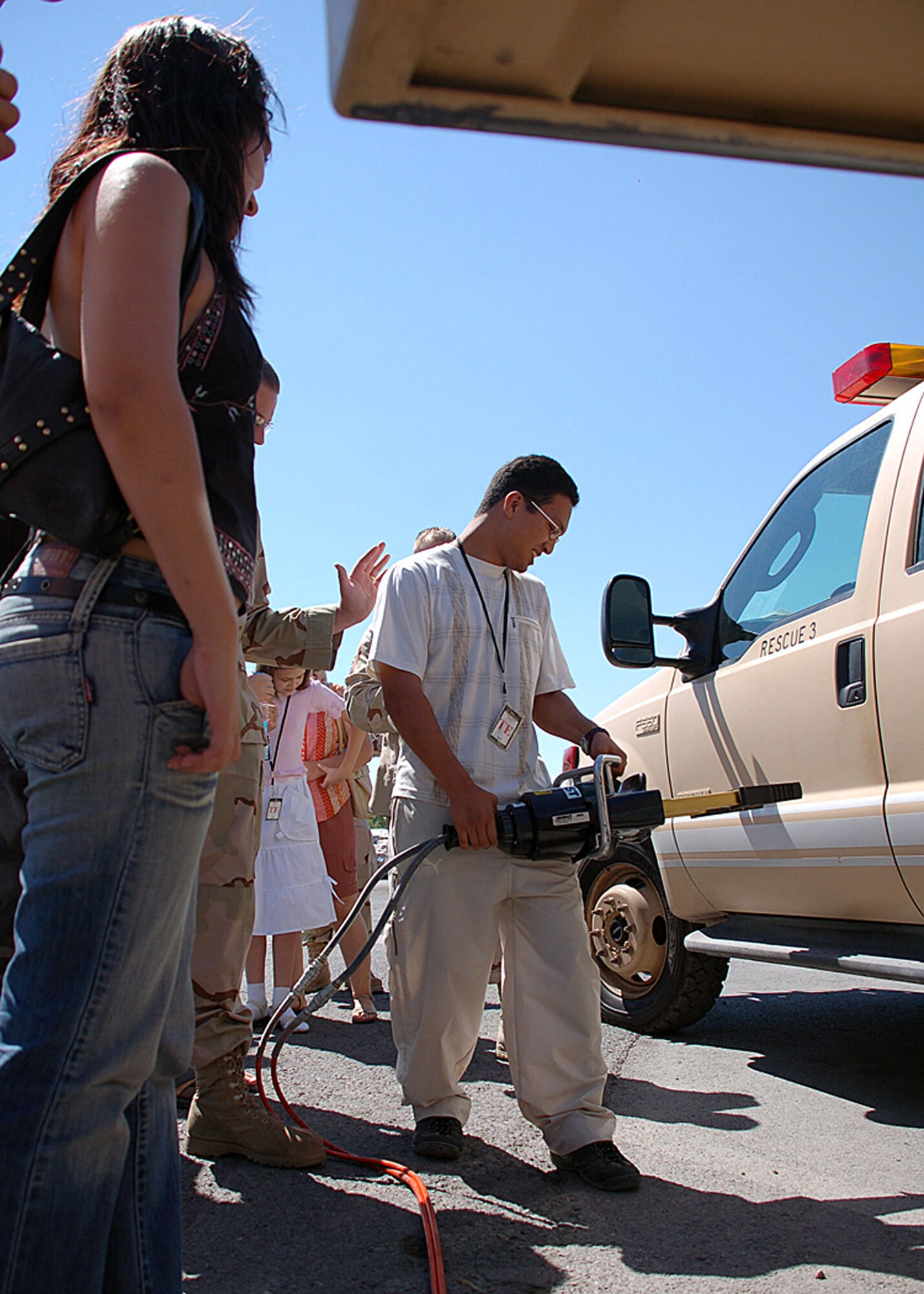 Ulan Umetov, a Kyrgyz student from a local medical lyceum, tries a Hurst hydraulic spreader during the group?s visit of Manas.  The hydraulic spreader is an auto extrication tool used for spreading open doors.  (Air Force photo by Maj. Adriane Craig)

