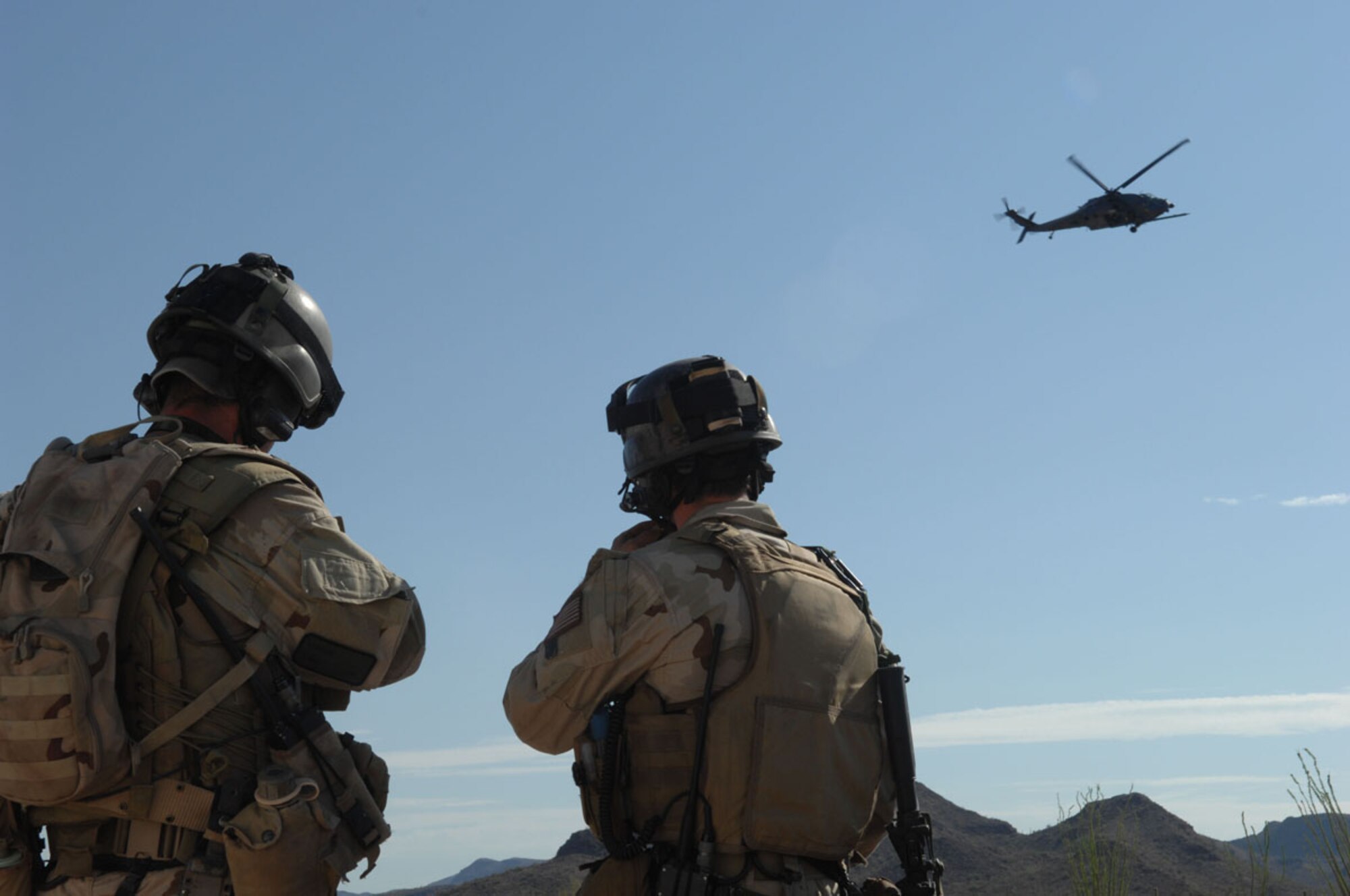 Pararescuemen from the 48th Rescue Squadron watch as a 55th RQS HH-60 prepares to land for evacuation procedures during exercise Angel Thunder. Angel Thunder is a combat search and rescue task force exercise designed to test theater spin-up capabilities and examine the integration of all Air Force assets in mission planning procedures and mission execution. (U.S. Air Force photo/Staff Sgt Lanie McNeal)