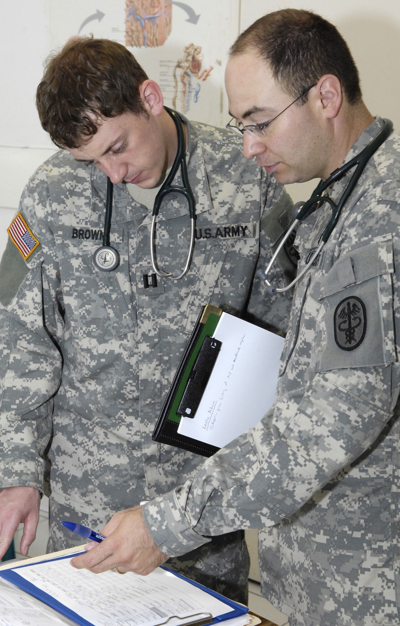 Dr. (Capt.) Evan Brown and Dr. (Maj.) Noah Solomon review a dialysis patient's records at Nauru General Hospital July 23. Dr. Brown and Dr. Solomon are part of a 12-person joint force team from U.S. Pacific Command providing medical assistance and training on the island of Nauru. (U.S. Air Force photo Tech. Sgt. Chris Vadnais)