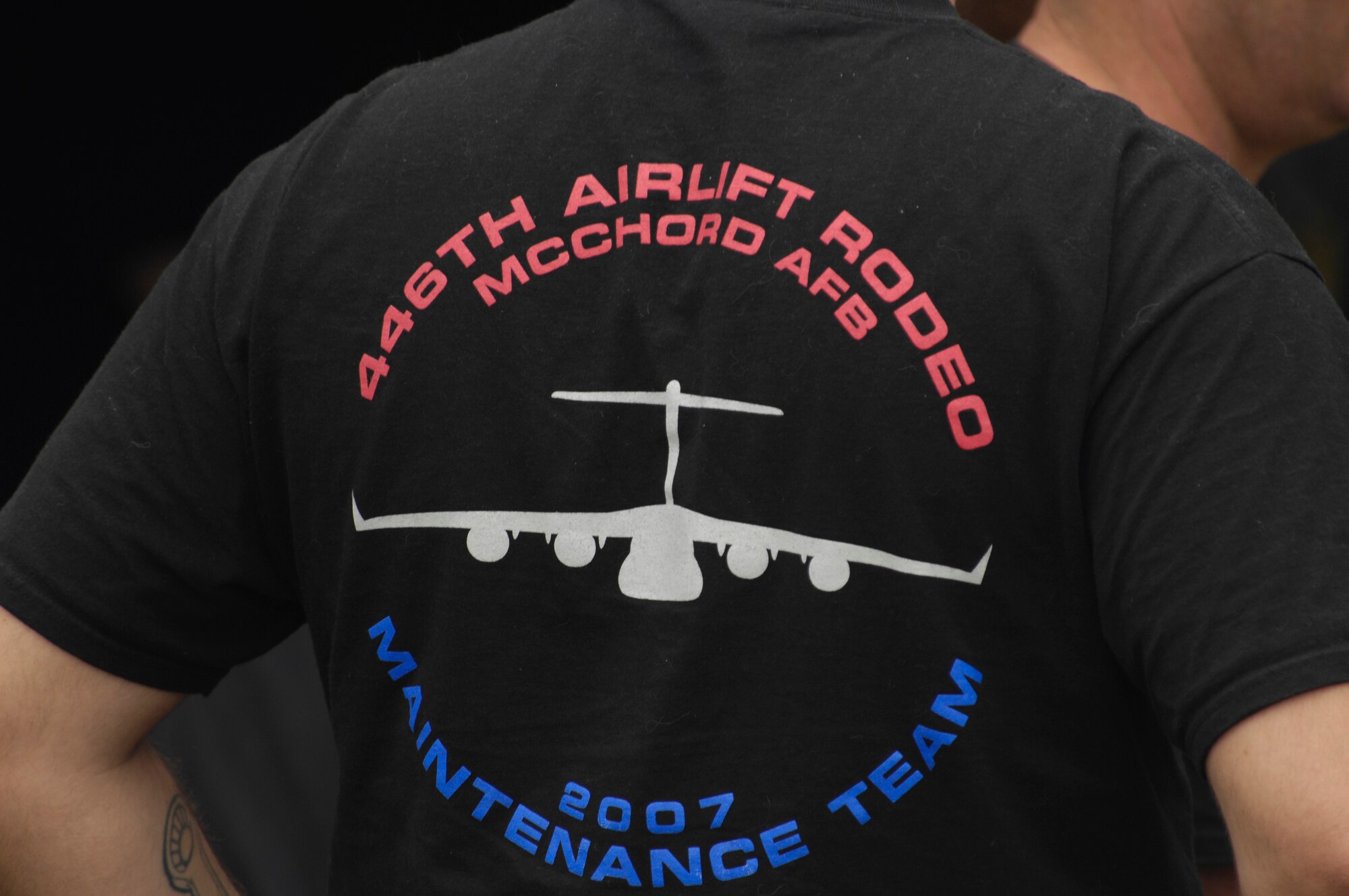 An Air Mobility Rodeo 2007 team member from the 446th Airlift Wing team demonstrates his esprit de corps by wearing his team shirt during activity for Rodeo at McChord Air Force Base, Wash., July 22.  Air Mobility Command's Rodeo 2007 is a readiness competition of U.S. and international mobility air forces.  It focuses on improving warfighting capabilities and support of the Global War on Terrorism.  (U.S. Air Force Photo/Tech. Sgt. Kevin P. Milliken) 
