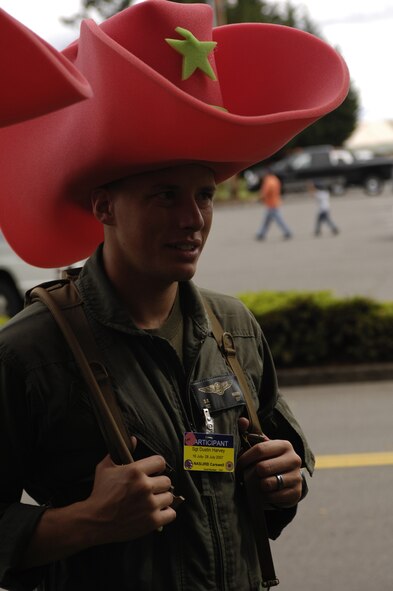 U.S. Marine Corps Sgt. Dustin Harvey of Carswell Naval Air Station, N.C., watches contestants in the Fit to Fight competition during Air Mobility Rodeo 2007 at McChord Air Force Base, Wash., July 21.  Air Mobility Command's Rodeo 2007 is a readiness competition of U.S. and international mobility air forces.  It focuses on improving warfighting capabilities and support of the Global War on Terrorism.  (U.S. Air Force photo/Tech. Sgt. Kevin P. Milliken)