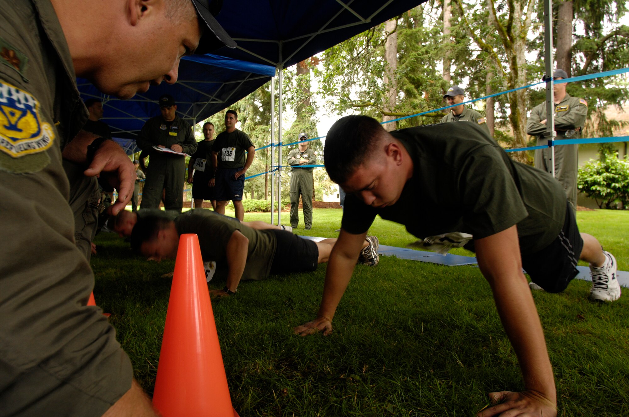 U.S. Marine Corps participants in the Fit to Fight competition complete the push-up event during Air Mobility Rodeo 2007 at McChord Air Force Base, Wash., July 21.  Air Mobility Command's Rodeo 2007 is a readiness competition of U.S. and international mobility air forces.  It focuses on improving warfighting capabilities and support of the Global War on Terrorism.  (U.S. Air Force Photo/Tech. Sgt. Kevin P. Milliken) 