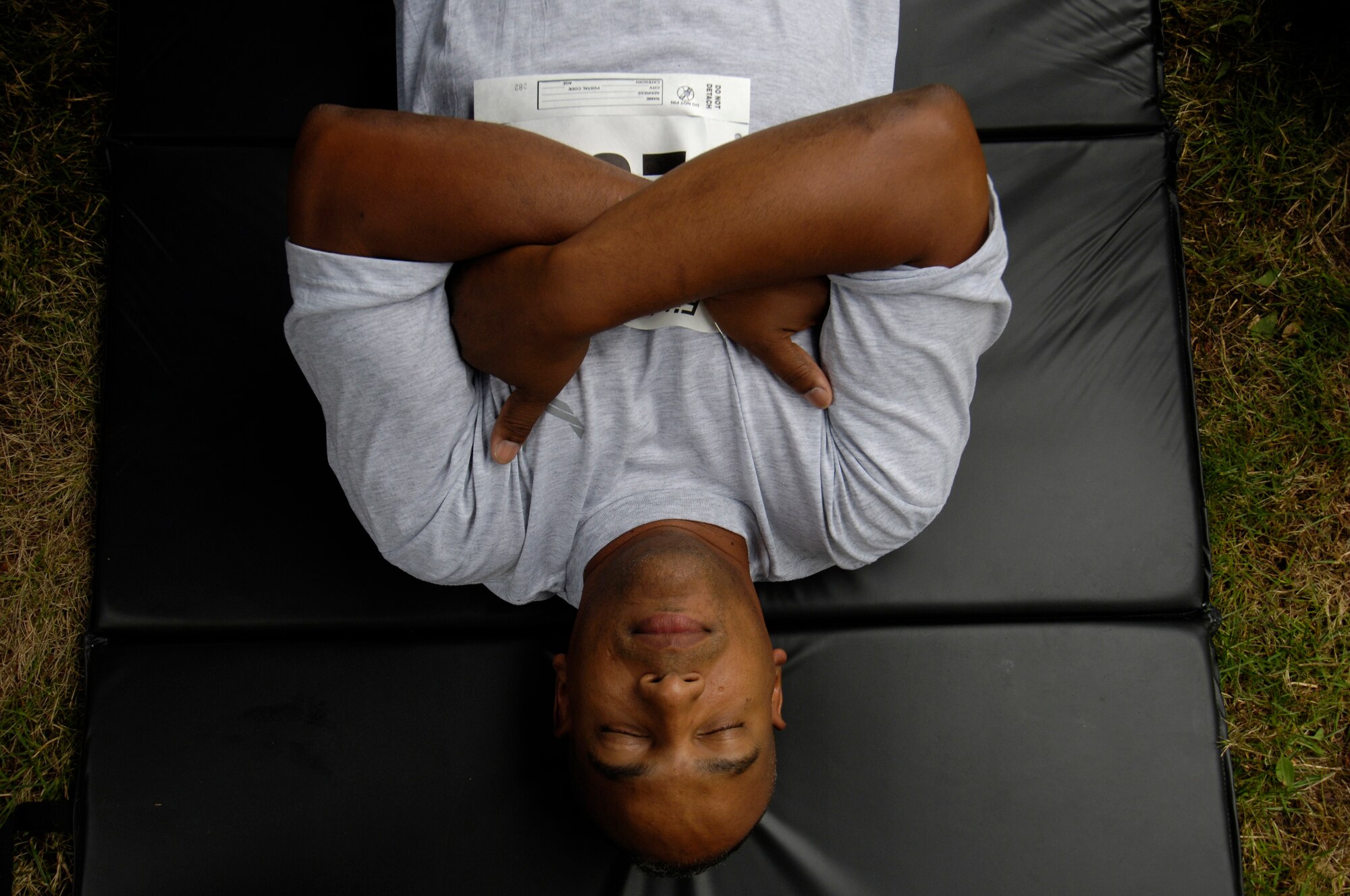 Senior Airman Abraham Tupe, a KC-1O maintainer from the 714th Aircarft Maintenance Squadron, McGuire Air Force Base, N.J., rests just before beginning the push-ups portion of the Fit-to-Fight competition at Air Moblity Command's Rodeo 2007, at McChord AFB, Wash., July 21. This is Airman Tupe's first Rodeo competition. "It's exciting, I guess. I don't know what to expect yet."  Air Mobility Command's Rodeo 2007 is a readiness competition of U.S. and international mobility air forces.  It focuses on improving warfighting capabilities and support of the Global War on Terrorism.   (U.S. Air Force photo/Senior Airman Clay Lancaster)

