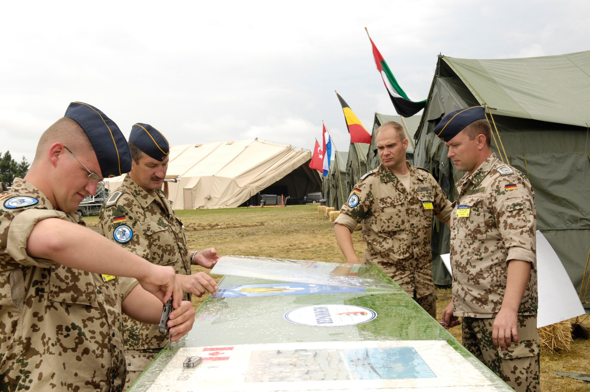 Members of the German team for Air Mobility Rodeo 2007 put together their bar in front of their tent in "Rainier Ranch" on McChord Air Force Base, Wash., on July 17. Rodeo 2007, hosted by Air Mobility Command, is a readiness competition of U.S. and international mobility forces.  It focuses on improving warfighting capabilities and support of the Global War on Terrorism. (U.S. Air Force Photo/Airman First Class Bryan Boyette)
