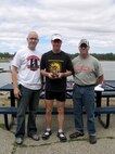 CLEAR LAKE, Wash. – Tech. Sgt. Michael Borgquist (center), Washington Air National Guardsman activated to the 92nd Security Forces Squadron at Fairchild Air Force Base, Wash., accepts his trophy from Ed Nunn, 92nd Services Squadron deputy commander (left), and John Gahagan, 92nd SVS fitness center director. Sergeant Borgquist had the shortest triathlon time at 1:06:48, and his wife, Amanda, broke the female Clear Lake record with a time of 1:21:03. Both athletes are regular competitors. (U.S. Air Force photo/ Staff Sgt. Connie L. Bias)