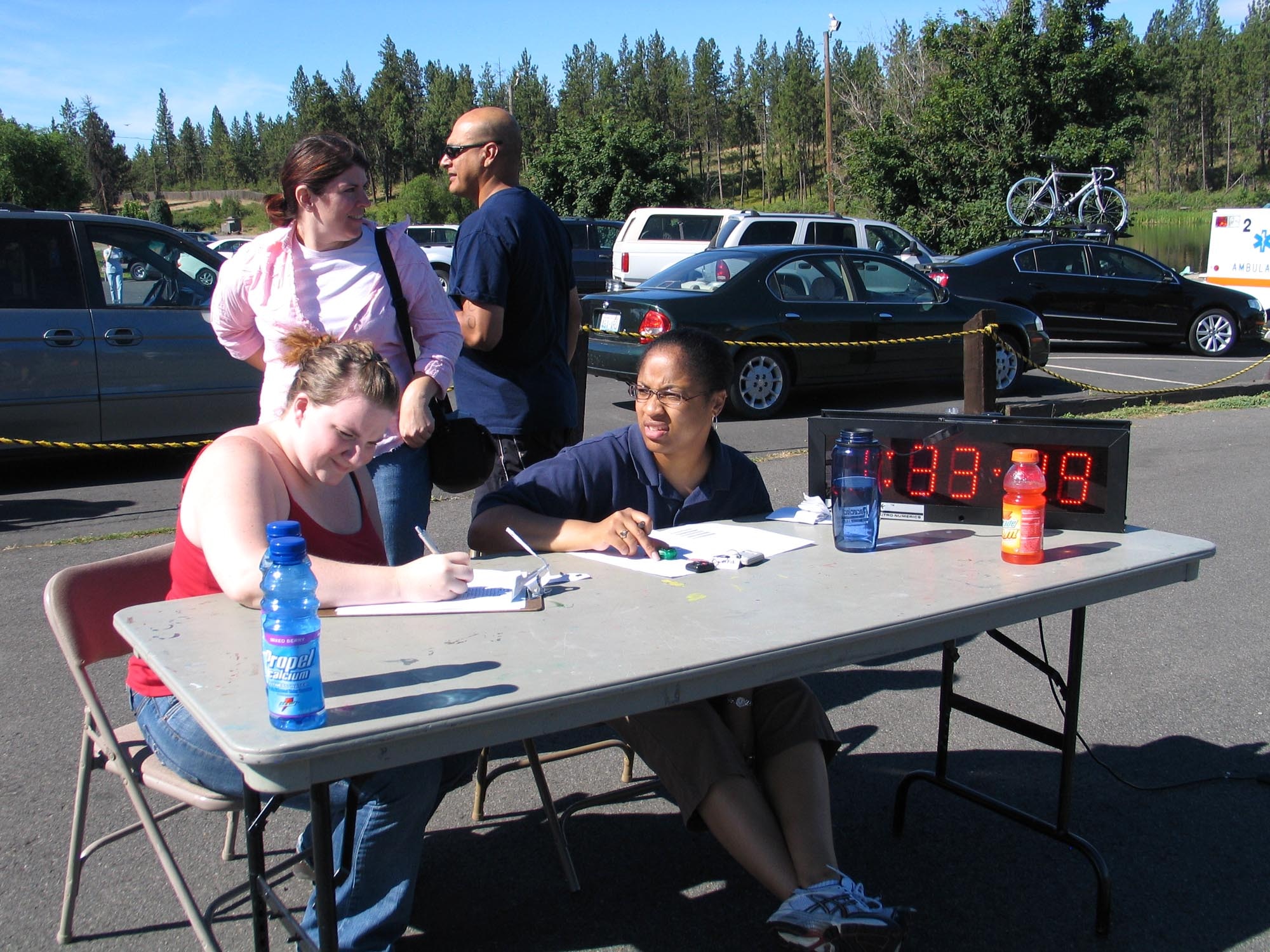 CLEAR LAKE, Wash. – From the left, Tech. Sgt. Miranda McKenzie, 92nd Services Squadron at Fairchild Air Force Base, Wash., and Jessica Daniel, volunteer, log final times for athletes at the annual Clear Lake Triathlon here July 21. More than 20 volunteers spent the day directing traffic, flagging athletes, acting as life guards, performing motorcycle patrol, and filling a host of other job descriptions. The volunteers are crucial to the triathlon’s success, according to John Gahagan, 92nd Services Squadron fitness center director at Fairchild Air Force Base, Wash. “Without these volunteers, we just cannot make it happen,” he said. (U.S. Air Force photo/ Staff Sgt. Connie L. Bias)