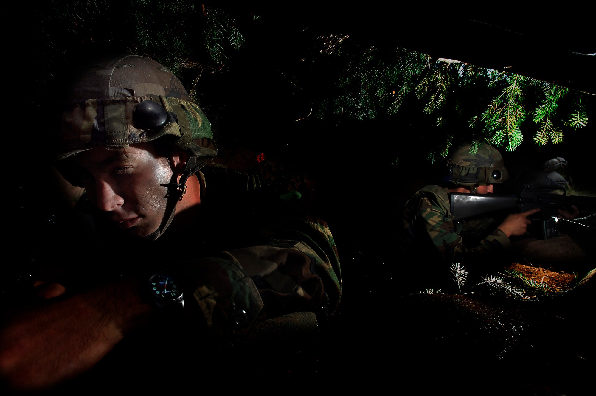 Cadets Zach Colvin, left, and Ryan Legault scan for the "enemy" during the early stage of an attack at Global Engagement, a summer course at the U.S. Air Force Academy in Colorado Springs, Colo.  Global Engagement teaches cadets the expeditionary Air Force concept of deploying, establishing a bare-base operation, executing their mission, defending their base and re-deploying home.  (U.S. Air Force photo/Tech. Sgt. Larry A. Simmons) 