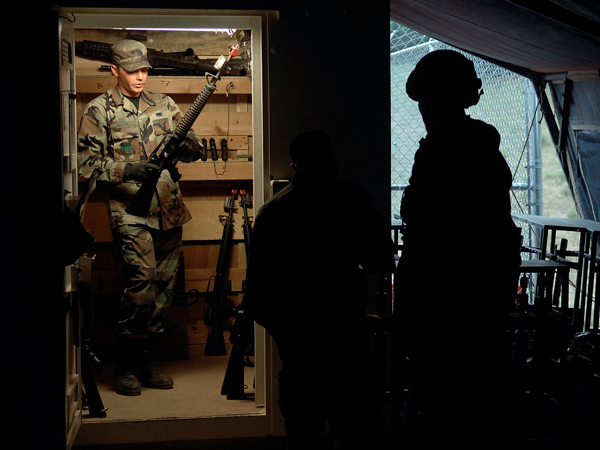 Cadet Ryan Weaver prepares to hand out M-16 rifles to other cadets July 13 during Global Engagement, a summer course at the U.S. Air Force Academy in Colorado Springs, Colo.  Global Engagement teaches cadets the expeditionary Air Force concept of deploying, establishing a bare-base operation, executing their mission, defending their base and re-deploying home.  (U.S. Air Force photo/Tech. Sgt. Larry A. Simmons) 