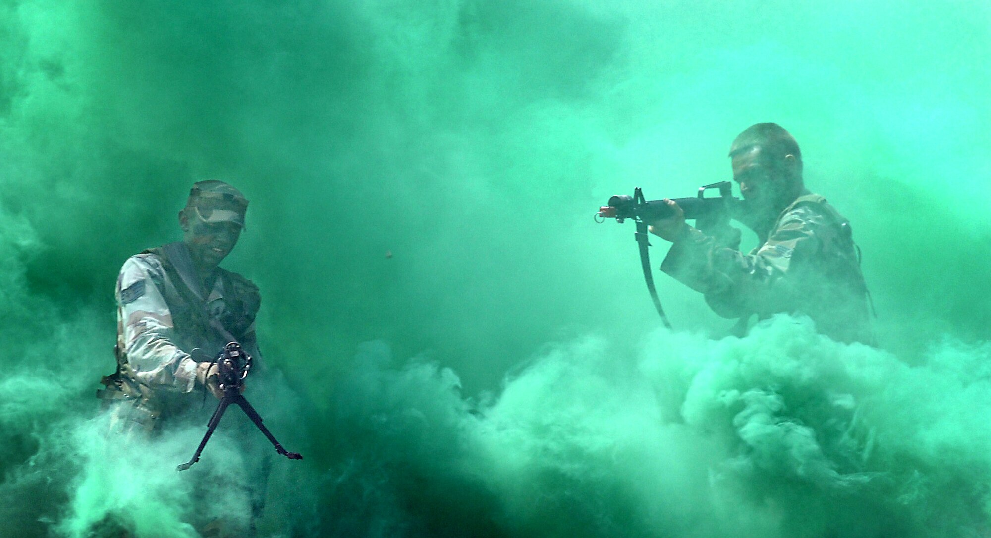 Staff Sgt. Jeremiah Johnson, left, fires an M-240 weapon while Senior Airman Arthur Sgruggs fires an M-16 July 13 during Global Engagement, a summer course at the U.S. Air Force Academy in Colorado Springs, Colo.  Global Engagement teaches cadets the expeditionary Air Force concept of deploying, establishing a bare-base operation, executing their mission, defending their base and re-deploying home.  (U.S. Air Force photo/Tech. Sgt. Larry A. Simmons) 
