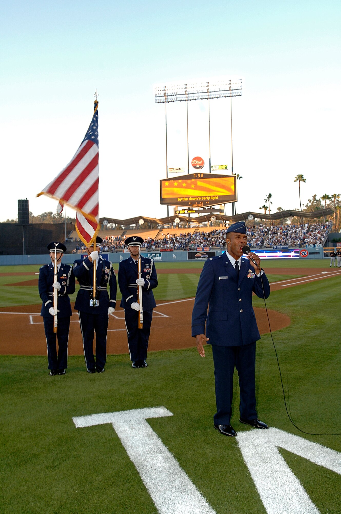Lt. Col. Ivan Thompson, SMC,  sings the National Anthem and a Los Angeles Air Force Base Honor guard posts the colors at a Los Angeles Dodger game, July 20. The annual Dodger Day event is sponsored by the City of El Segundo. (Photo by Paul Testerman)