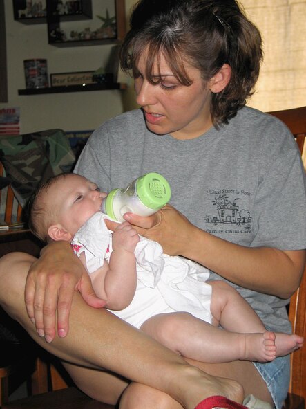 FAIRCHILD AIR FORCE BASE, Wash. – Tobie Dreiling, Family Child Care provider here, feeds Malieah Rickert, 4 months, after the infant’s afternoon nap. Mrs. Dreiling watches four full-time children and five drop-ins throughout the week, along with her own children, 5-year-old Caleb and 14-year-old Alyssa. (U.S. Air Force photo/ Staff Sgt. Connie L. Bias) 
