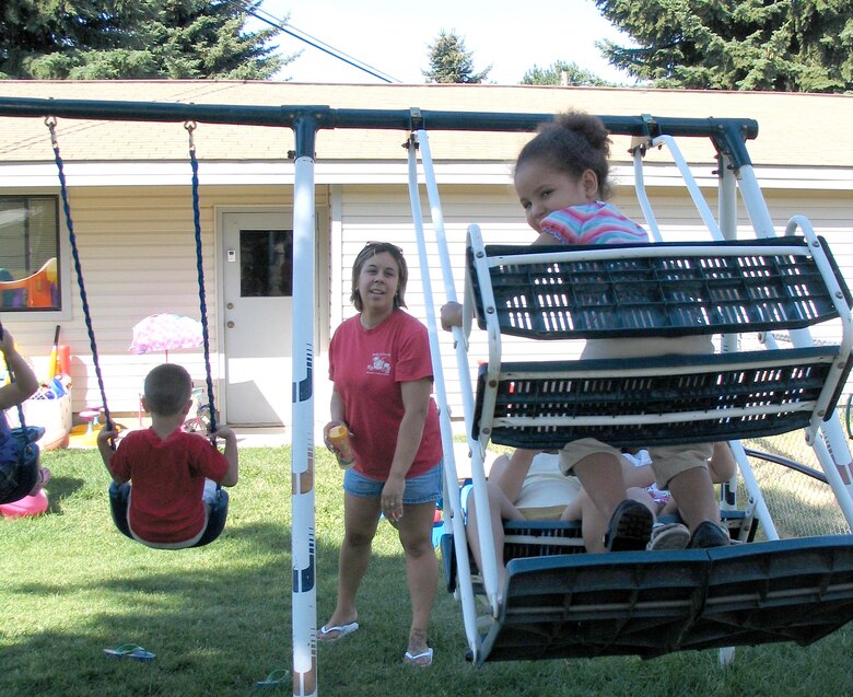 FAIRCHILD AIR FORCE BASE, Wash. – Brianna Evans gives her daycare children a push on her backyard swing set. Ms. Evans is a Family Child Care provider here, and was named Fairchild Rookie of the Year for 2006. The provider said when she heard of the award she was “shocked – I didn’t even know they had such an award here.” (U.S. Air Force photo/ Staff Sgt. Connie L. Bias)