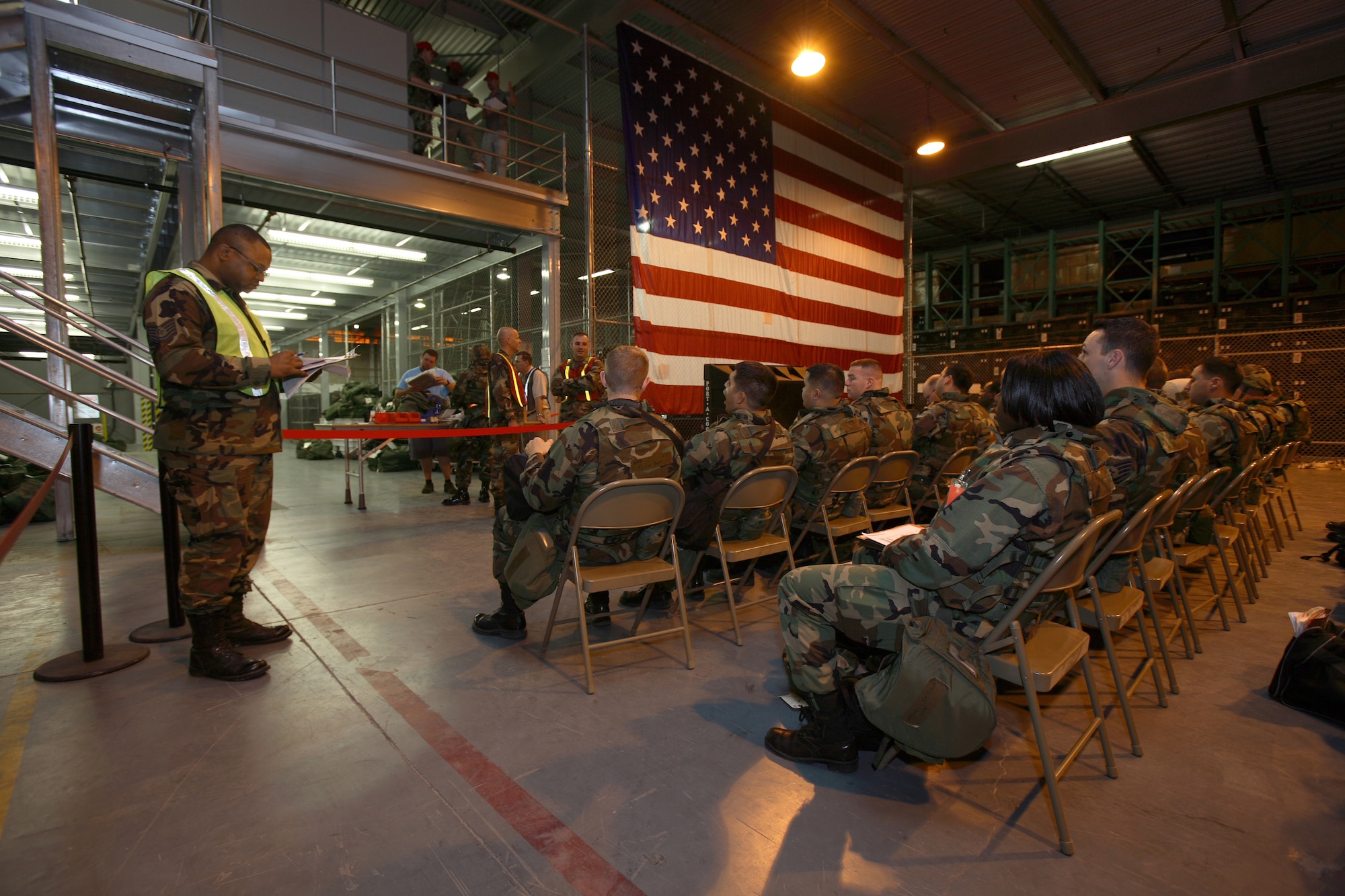 A base readiness manager checks a manifest on the deployment line during the Phase I exercise July 19. This is the first exercise where Team Edwards processed 200 people through the line within 12 hours. (Photo by Jet Fabara)  