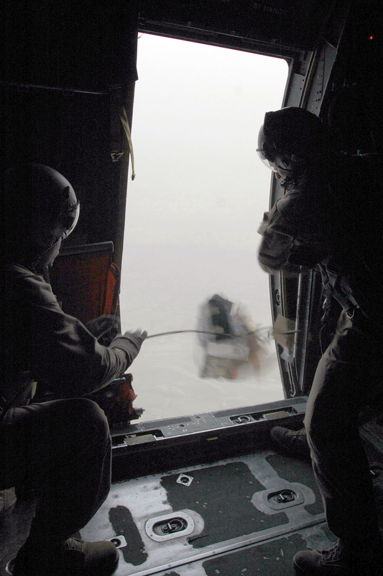 Master Sgt. Larry Lambert, 746th Expeditionary Airlift Squadron senior loadmaster, and Senior Airman Ronald Orr, 746th EAS mission loadmaster, release a box of leaflets over the objective area. The squadron successfully met their objective of dropping 120,000 leaflets over the Helmand Province, prepping the battlefield. (U.S. Air Force photo by Capt. Teresa Sullivan)